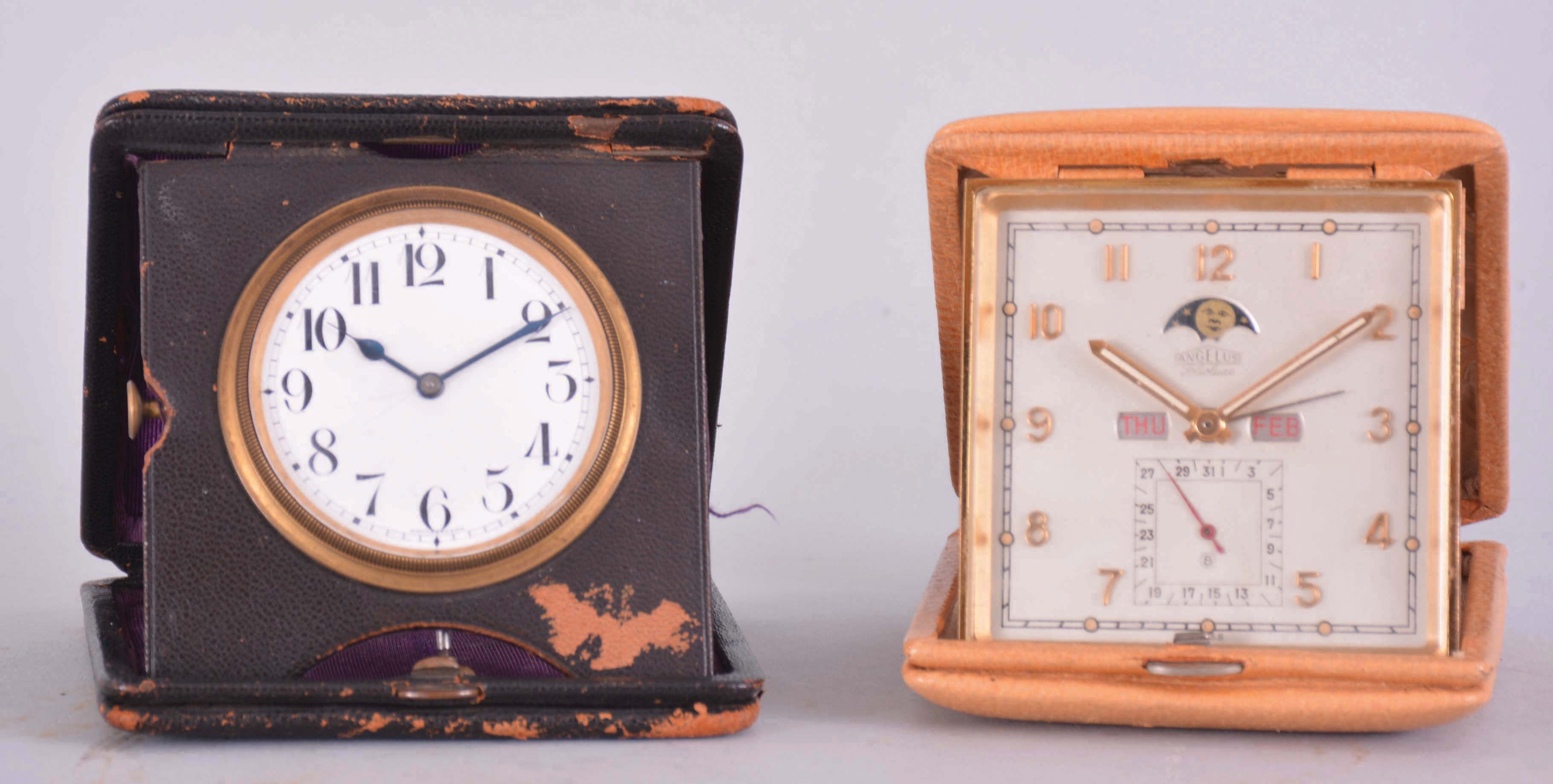 Clocks- 2 (Two): Both travel models, the first an Angelus "Folioluxe", 8 day, 15 jewel lever movement with triple calendar, phases of the moon, and alarm, Arabic numeral silvered dial, luminous baton hands, the other a minute repeater marked "Columbia Watch Co.", 13 jewel nickel movement with lever escapement, Arabic numeral white enamel dial with blued steel hands — Antique Clocks Price Guide