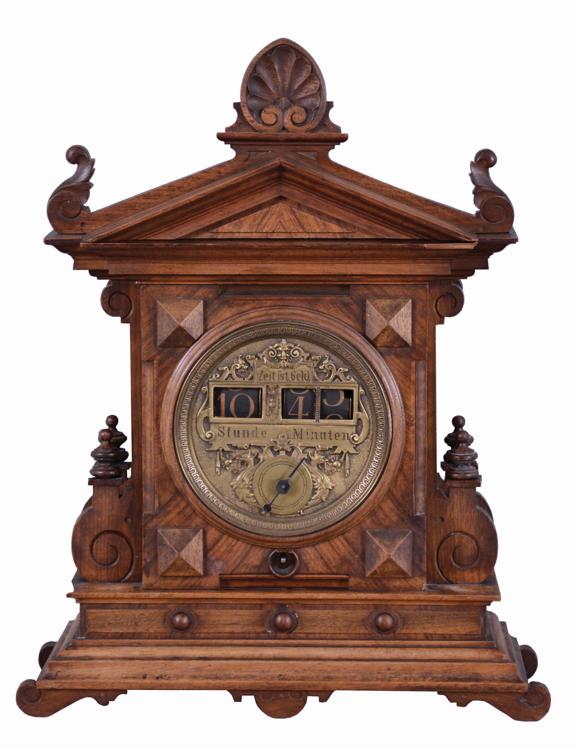 German "Digital Time" with fancy brass dial, in an architectural walnut case, brass pendulum regulated movement, has solid plates and open spring, running one day, gilt /tan numerals on paper rollers indicate the time, the right two rollers bearing the minutes, and rolling up similar to American calendar roller [or slot machine roller], springing quickly into next position. At the end of minute 59, the hour roller rotates, and the minutes are back to "00". — Antique Clocks Price Guide