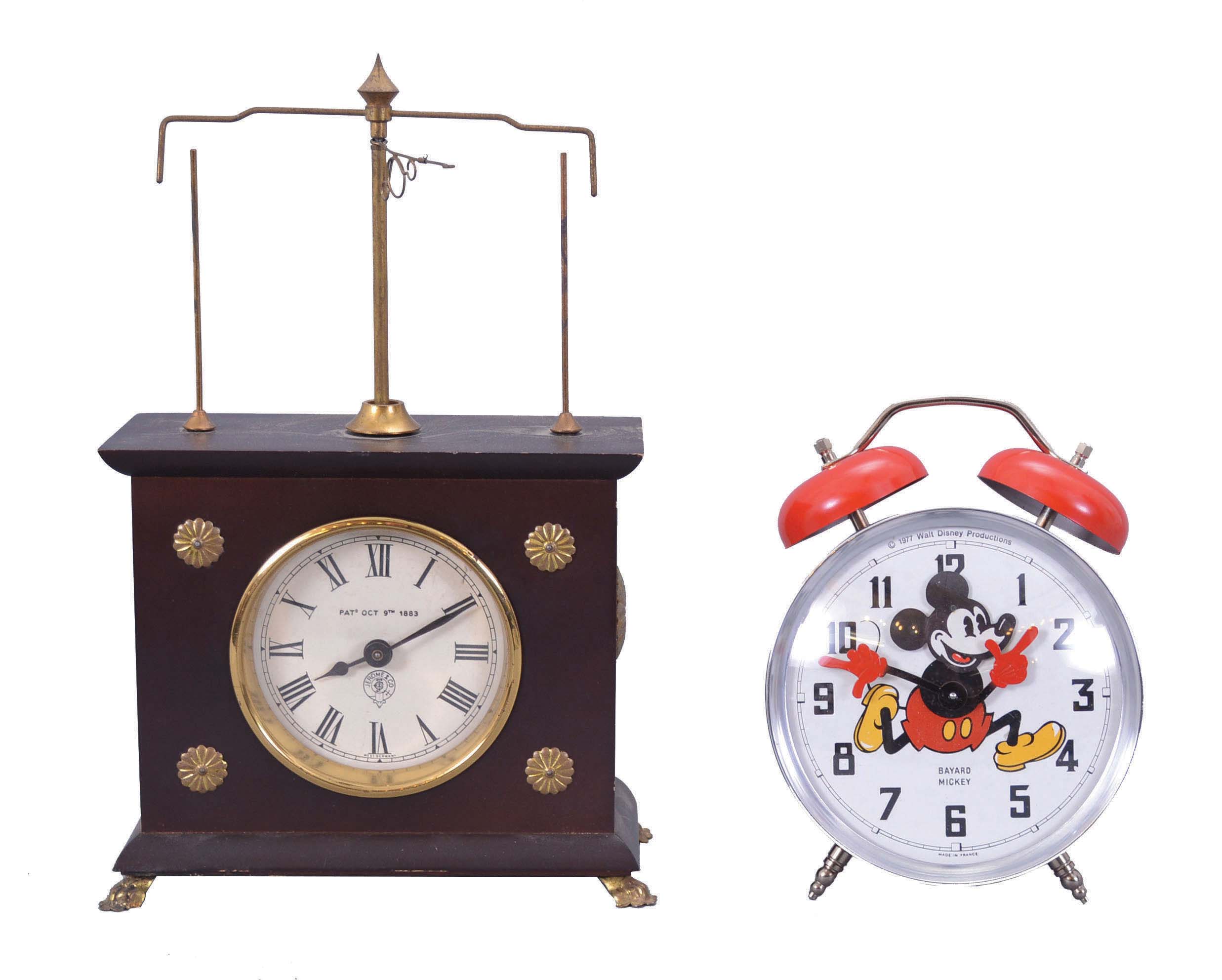 Clocks- 2 (Two) Novelty: (1) Horolovar Co., Bronxville, New York reproduction "Ignatz" flying pendulum novelty clock, reproduction of the model made by the New Haven Clock Co., c1970; (2) Reveils Bayard, France, "Mickey" alarm clock with external bells and rocking head Mickey Mouse figure, c1977. — Antique Clocks Price Guide