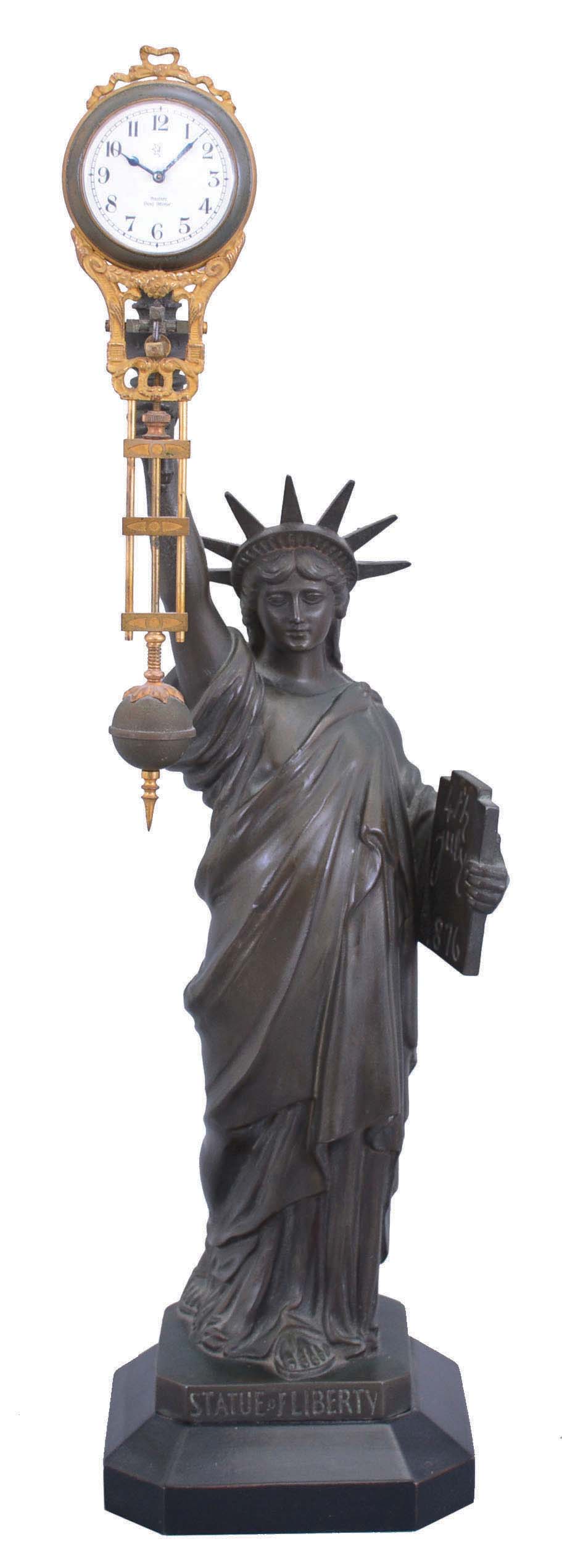 Germany, early 20th century, Junghans swinging arm timepiece, suspended from a spelter figure in the form of the Statue of Liberty. — Antique Clocks Price Guide