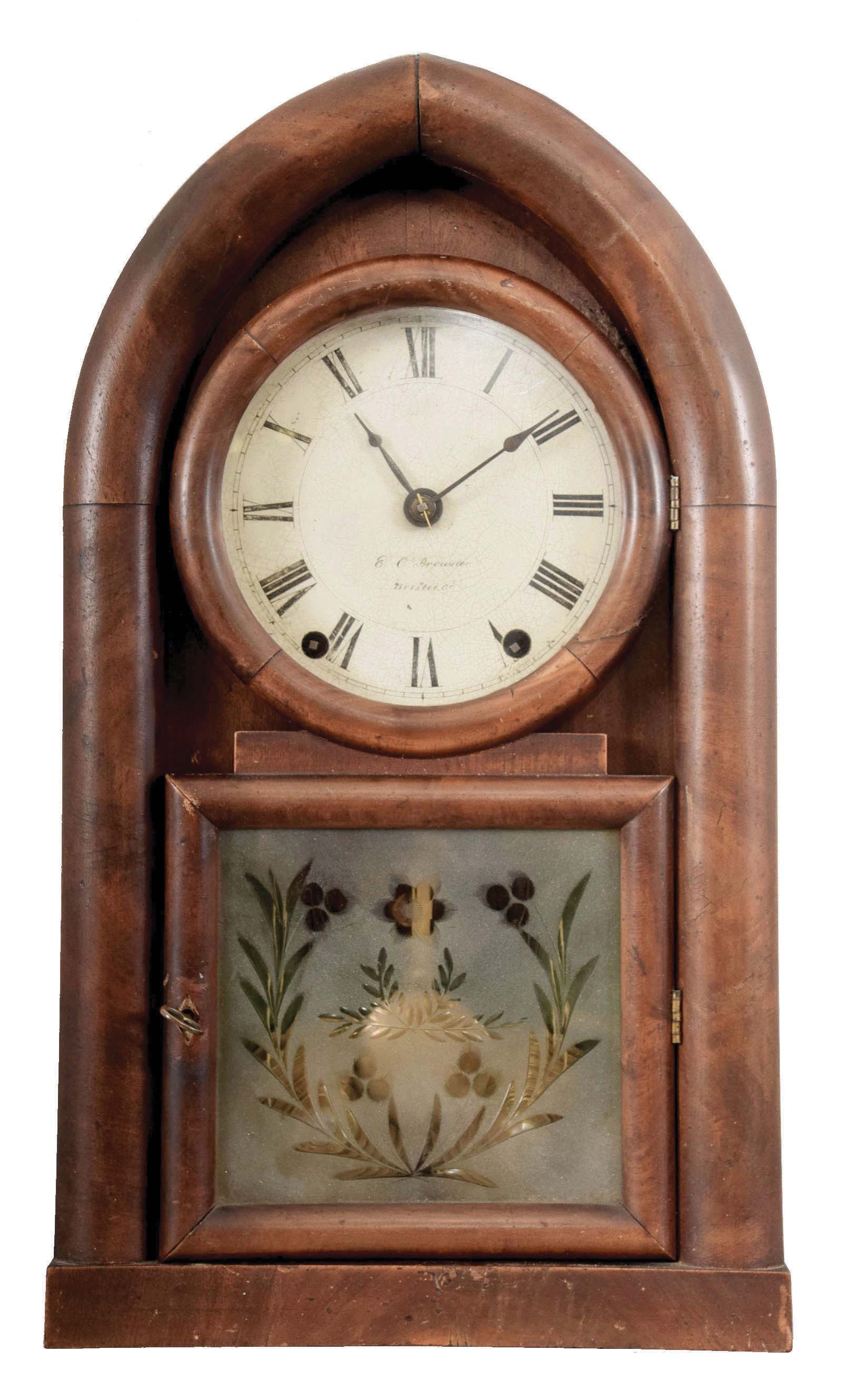 E. C. Brewster, Bristol, Conn., Round Gothic shelf clock with a spring driven, 8 day time and rack strike fusee movement in a mahogany veneered case. — Antique Clocks Price Guide