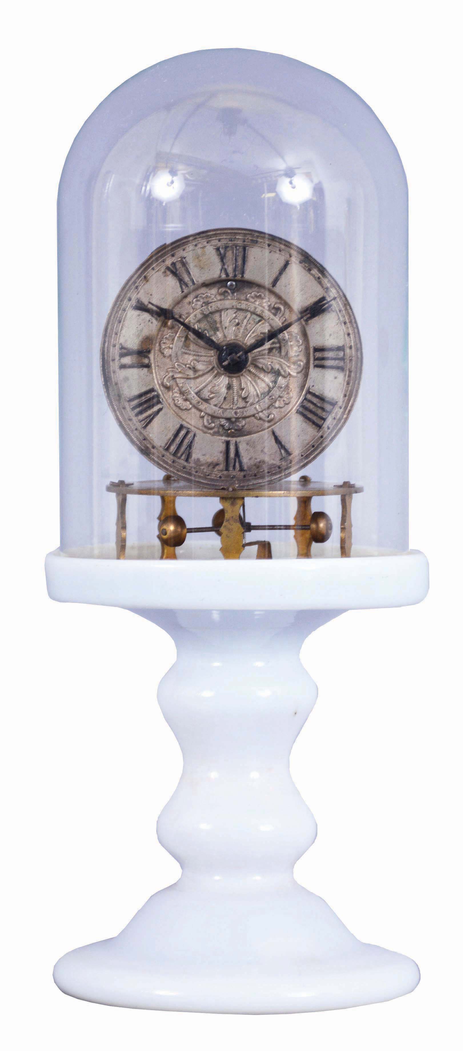 Ansonia Clock Co., Ansonia, Conn., 3 arm balance, Torsion Candlestick Timepiece with 2 3/4-in. embossed & silvered brass dial, thirty-hour timepiece with 3 small brass cups on the ends of the balance arms, hairspring, and regulator below the movement, back plate stamped Terry Ville Manufacturing Company, Terry Ville, Conn., Patented October 5th, 1852, milk glass pedestal and glass dome, — Antique Clocks Price Guide