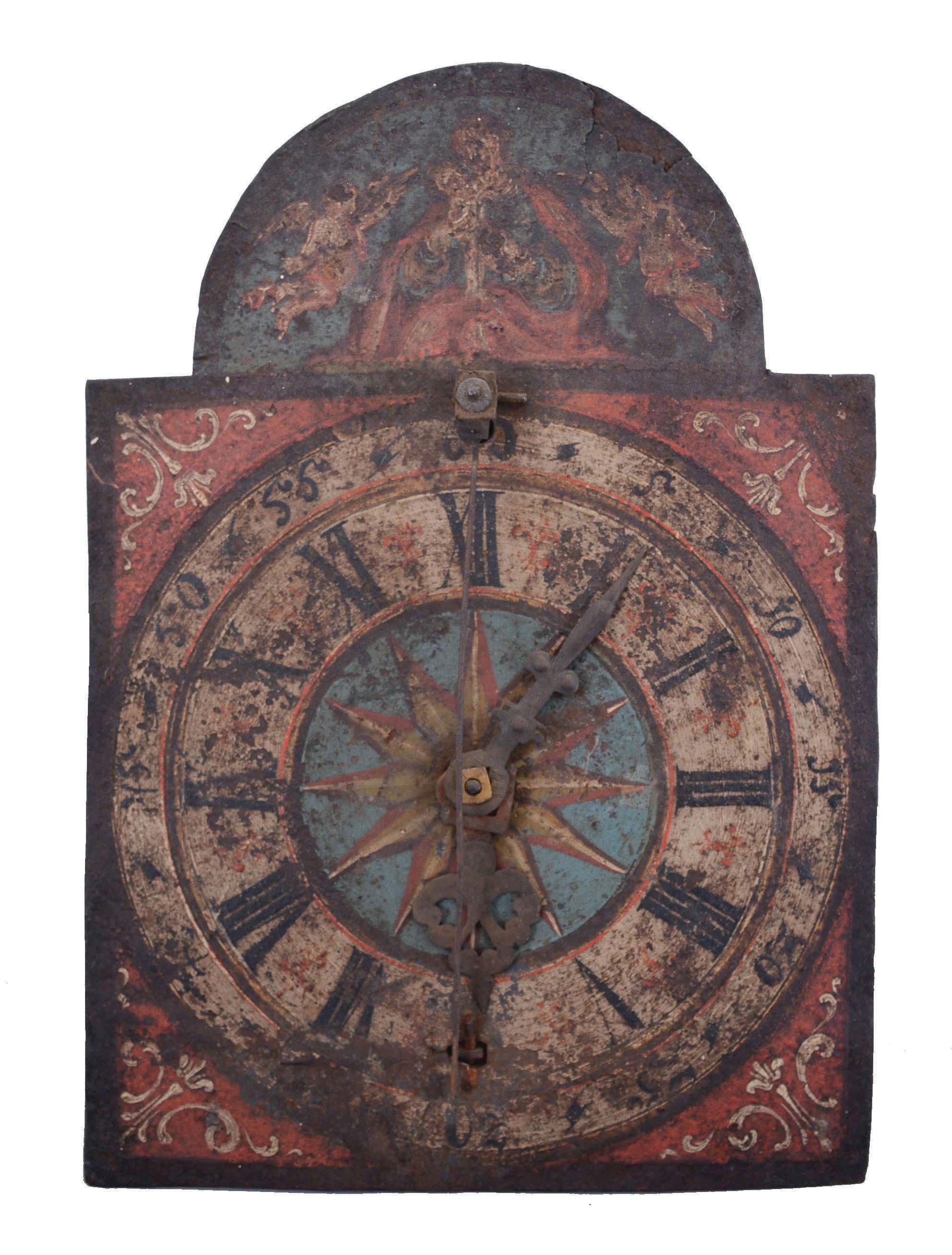 Italian, dial or shield clock, painted iron roman numeral dial, front hung cow's tail pendulum (lacking bob), one day duration posted iron frame movement with crown wheel and verge escapement, countwheel bell strike, rope drive. — Antique Clocks Price Guide