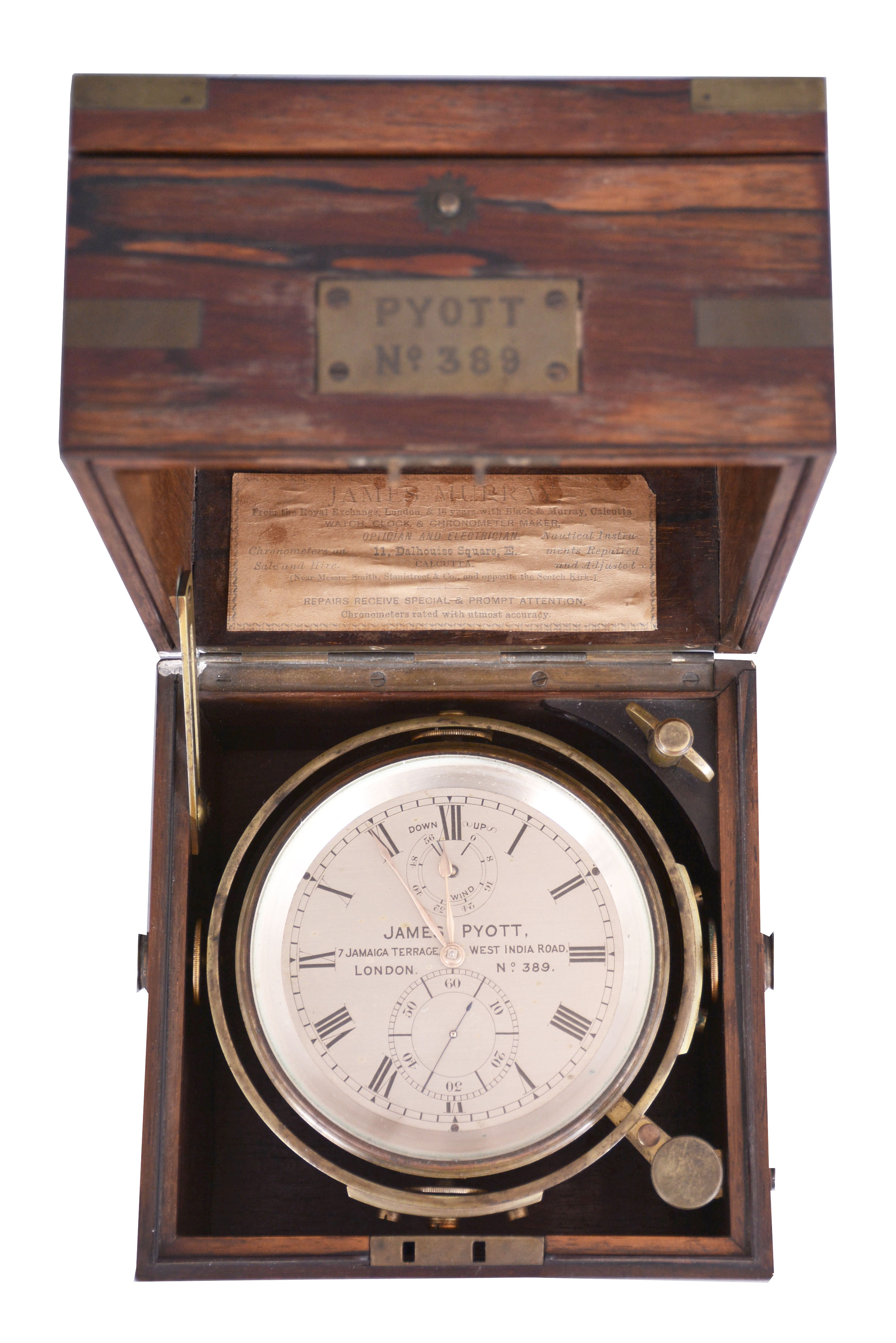 James Pyott, 7 Jamaica Terrace, London, a good two day marine chronometer with original box, 11 jewel, free sprung fusee movement with Earnshaw's spring detent, the Z balance with Poole's auxiliary compensation, blued, helical spring, and diamond endstone, Roman numeral silvered dial with wind indicator, gold spade and poker hands, contained in a lacquered brass bowl with gimbals, and mounted in a rosewood and rosewood veneer box with brass furniture, and brass plaque engraved "Pyott No. 389", the box also with the label of James Murray, Watch Clock, and Chronometer Maker, Calcutta — Antique Clocks Price Guide