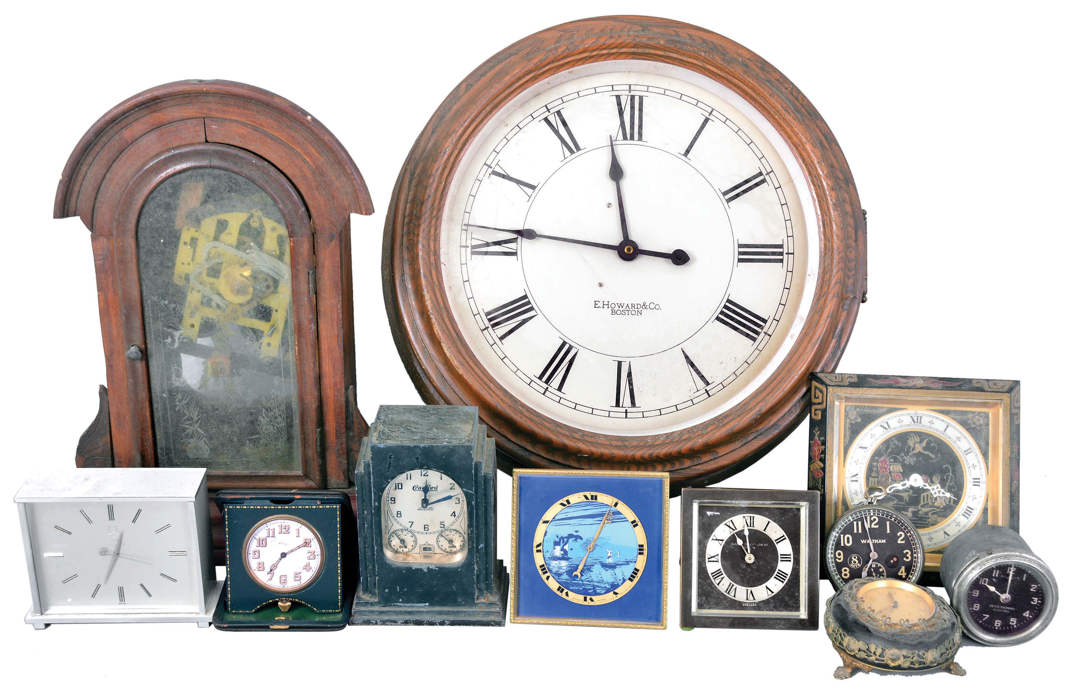 Clocks- 11 (Eleven) European and American Clocks: Lot includes 2 Chelsea easel clocks, one with the black "Chinese Lacquer" motif; Waltham 8 day clock clock; German made alarm clock; Lux "Automatic Range Timer"; Swiss-made 15 jewel travel clock; desk clock with Bulova Accutron movement; Swiss-made easel clock with blue dial; Seth Thomas electric car clock; mantel clock with Asian movement; E. Howard & Co. gallery clock fitted with a battery movement. — Antique Clocks Price Guide