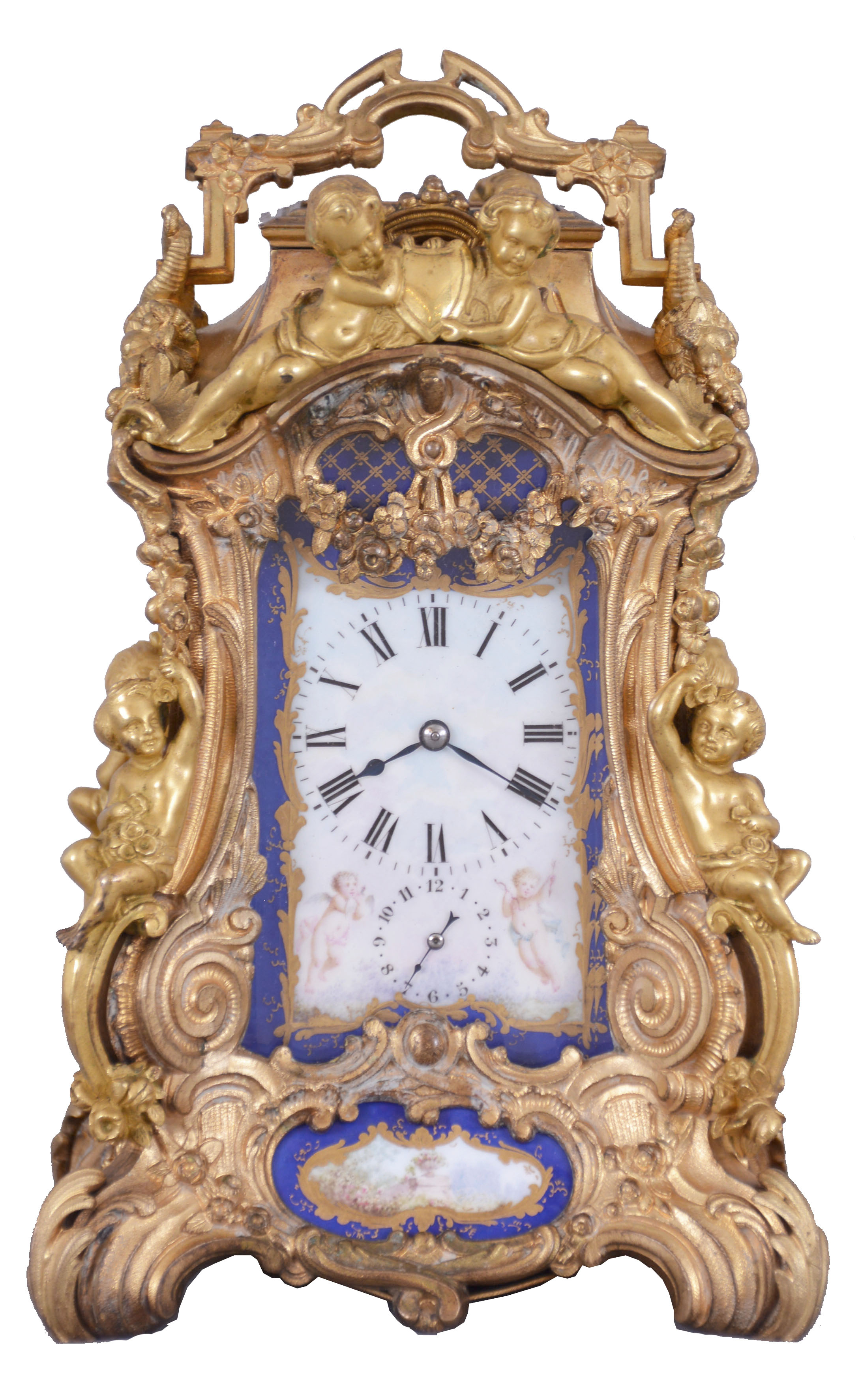 Attributed to Drocourt, Paris, a rare and extremely decorative giant carriage clock in the rococo style, the gilt case replete with scrolls, foliate ornament, and putti, and set with eight gilt and polychrome enamel porcelain plaques featuring garden scenes and frolicking amorini, each on a deep blue field with gilt, foliate border, the Roman numeral dial with blued steel hands, case back with sliding glass panel to allow access for winding and setting, 8 day time, strike, and alarm movement with lever platform, repeating the last hour on demand, gong base marked "A.D." within an oval, serial #29268 — Antique Clocks Price Guide