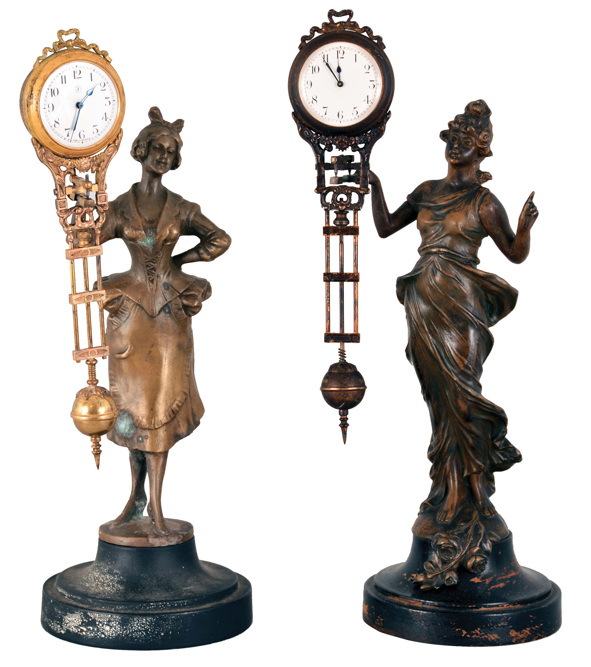 Clocks- 2 (Two) Mystery Swingers: (1) Diana with porcelain arabic numeral dial with Junghans logo mounted on the pendulum and suspended from the patinated figure's outstretched arm, one-day movement, all on an ebonized turned wooden base; (2) Country Lady in bustled dress and apron on a composite turned base, unmarked Arabic numeral porcelain dial and one-day movement. — Antique Clocks Price Guide