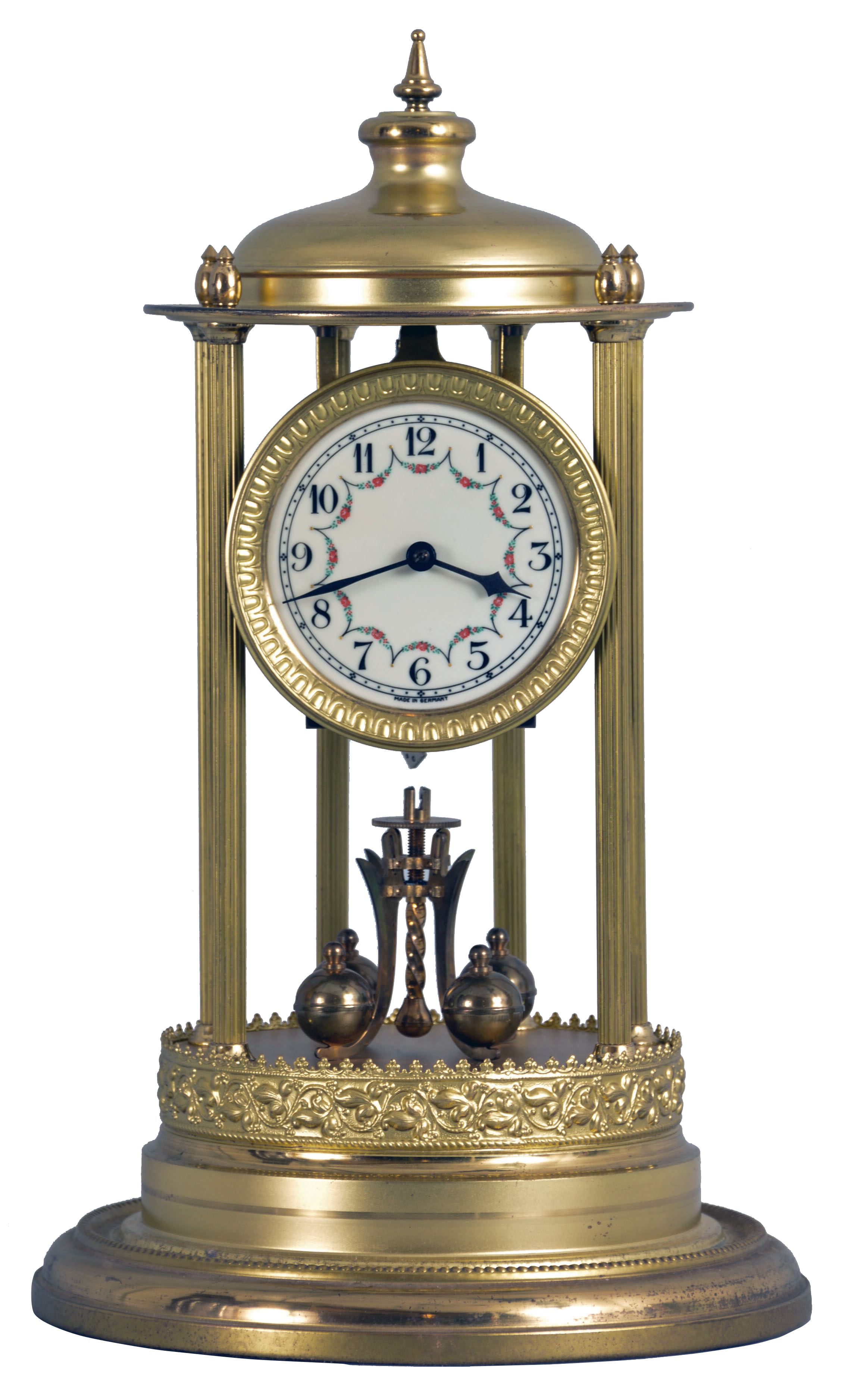 400-Hundred Day Torsion Pendulum Clock, Arabic numeral and floral decorated dial, year-duration spring powered brass movement marked on the reverse "Germany", six wheel train and torsion four ball pendulum, the brass gazebo form case with six fluted columns supporting the movement assembly, top cap with seven finials, all on a round base with pressed brass trim and covered by a glass dome. — Antique Clocks Price Guide