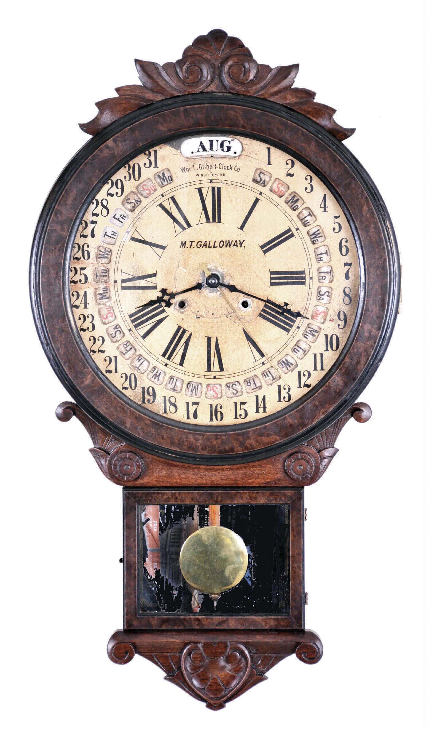 Wm. L. Gilbert Clock Co., Winsted, Conn., "Office Drop Calendar" clock, 8 day, time and strike, with Gilbert's version of the famous Maranville's calendar system, and in a walnut case with carved trim. — Antique Clocks Price Guide