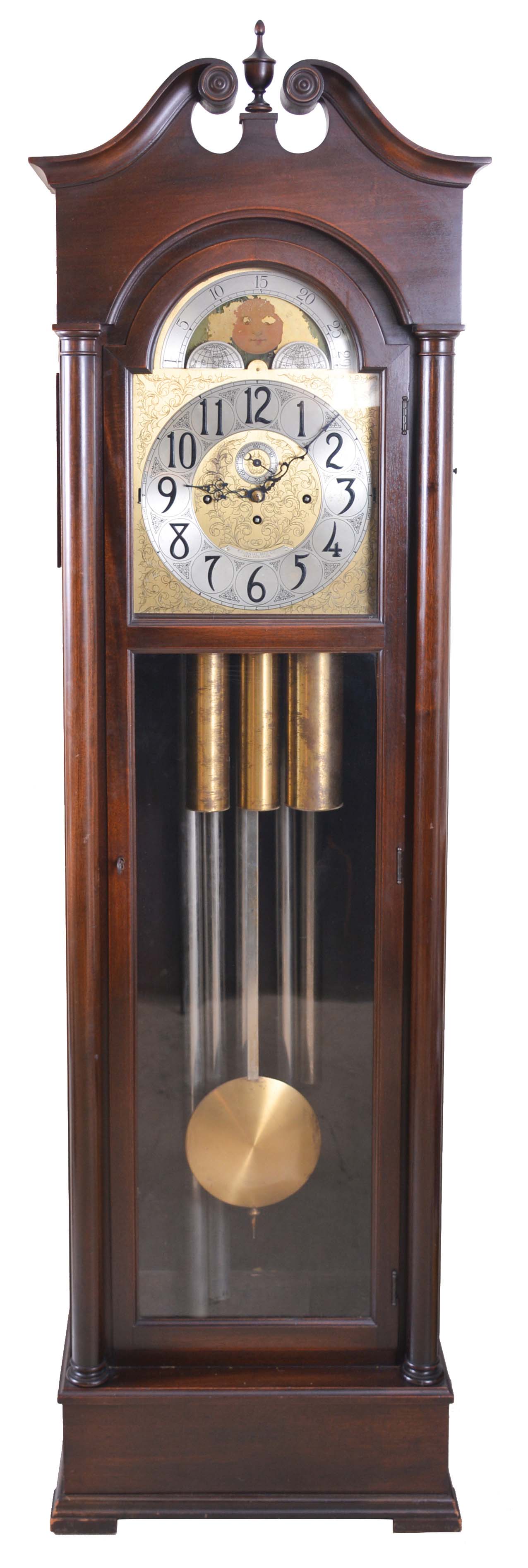 The Colonial Mfr. Co., Zeeland, Mich., tall case clock, 8 day, time, strike and five tubular chime, three brass weight driven movement in a mahogany case with a brass dial with silvered chapter ring, seconds bit and moon phase — Antique Clocks Price Guide