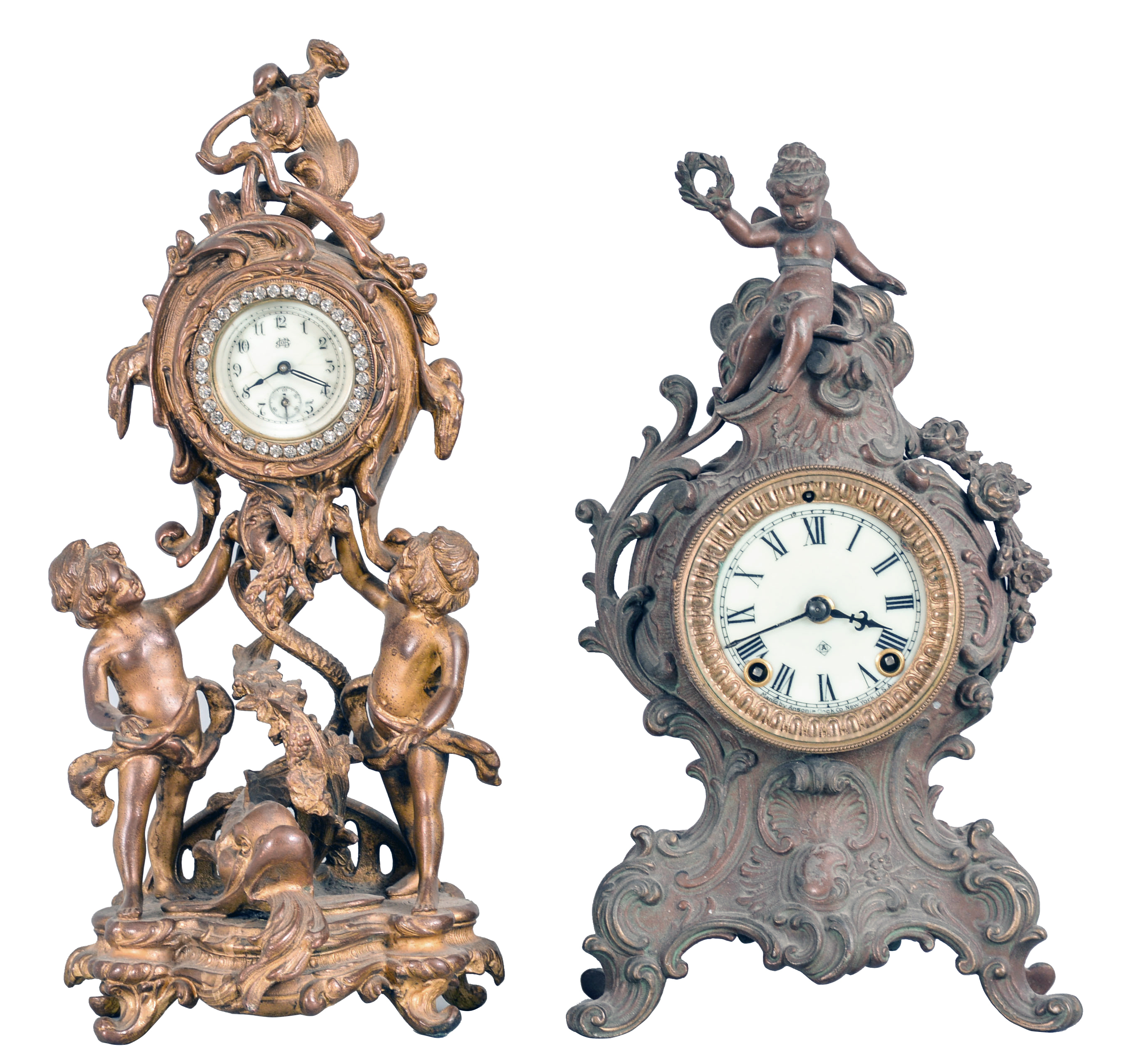 Clocks- 2 (Two): (1) Waterbury Clock Co., Waterbury, Conn., 30 hour, spring brass lever movement figural timepiece with brilliant surround dial, c1900; (2) Ansonia Clock Co., New York, "Cygnet", 8 day, time and strike, spring brass movement cast metal case with a figure on top mantel clock, c1904. — Antique Clocks Price Guide