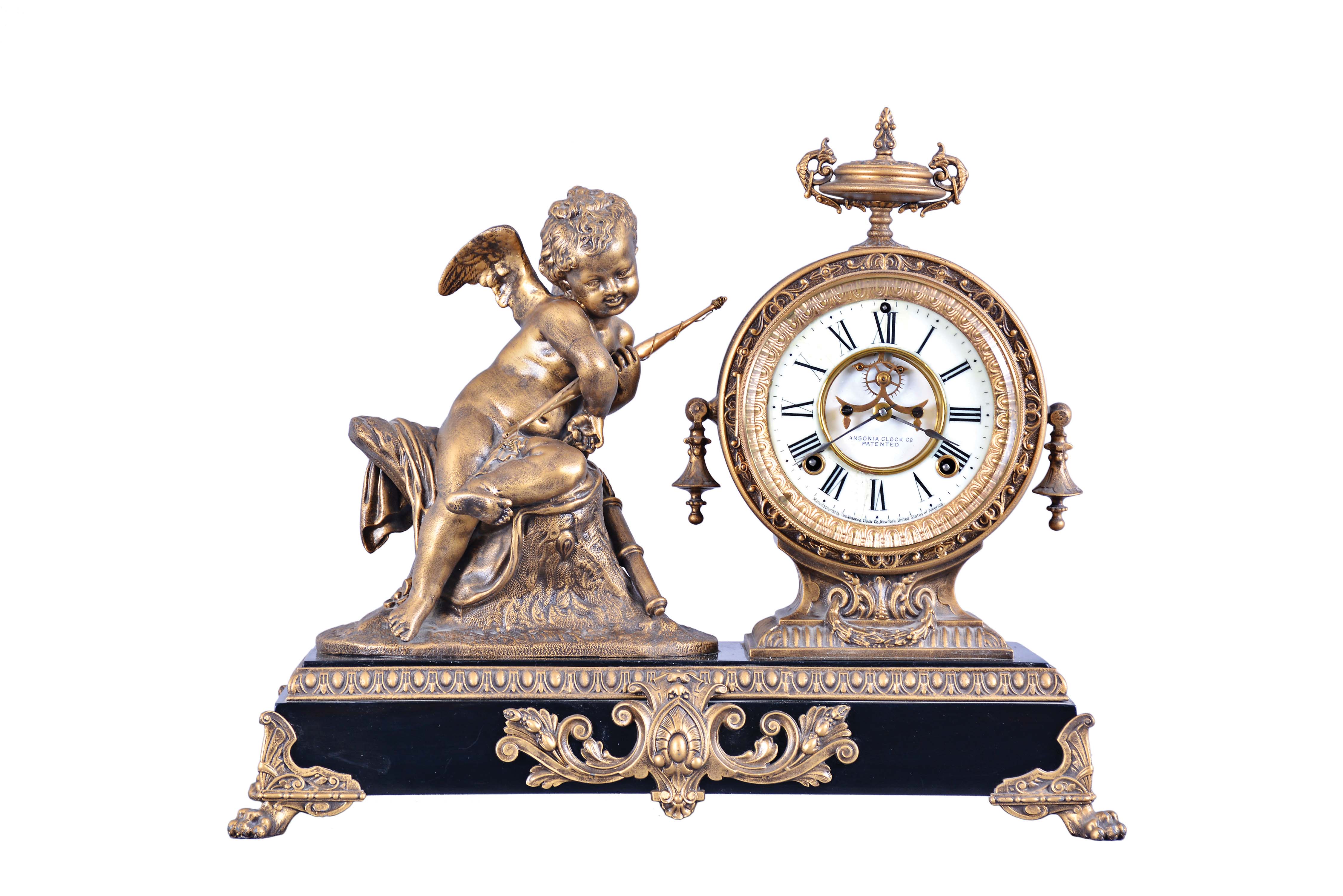 Ansonia Clock Co., New York, "Cupid", 8 day, time and strike, spring brass movement figural mantel clock. — Antique Clocks Price Guide