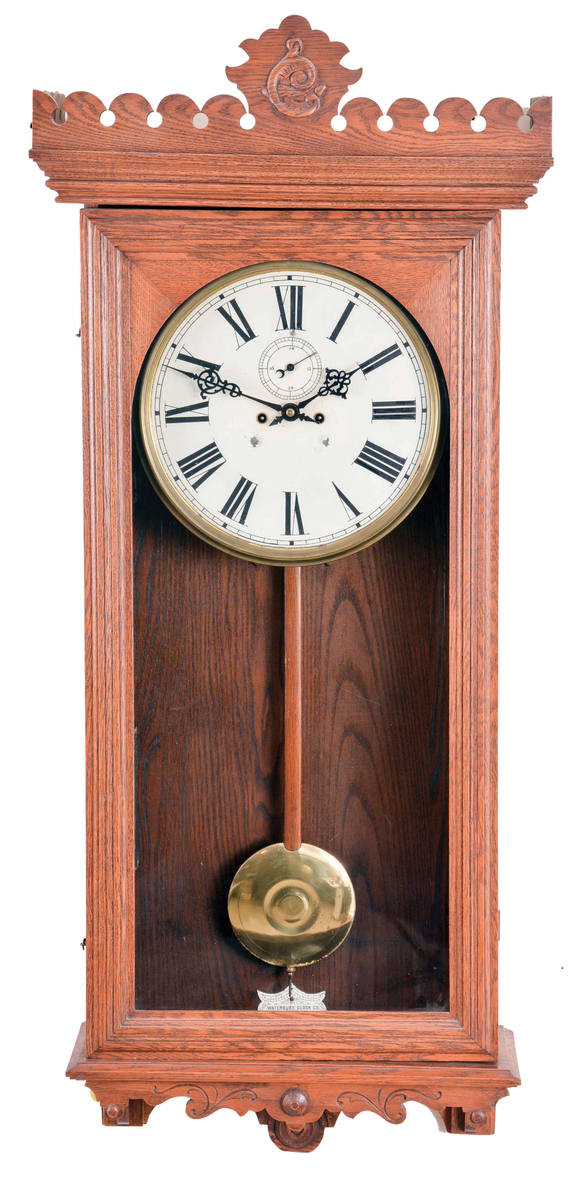 Waterbury Clock Co., Waterbury, Conn., "Regulator No. 18", wall clock, 8 day, time only, two weight driven movement in an oak case with a painted metal dial. — Antique Clocks Price Guide