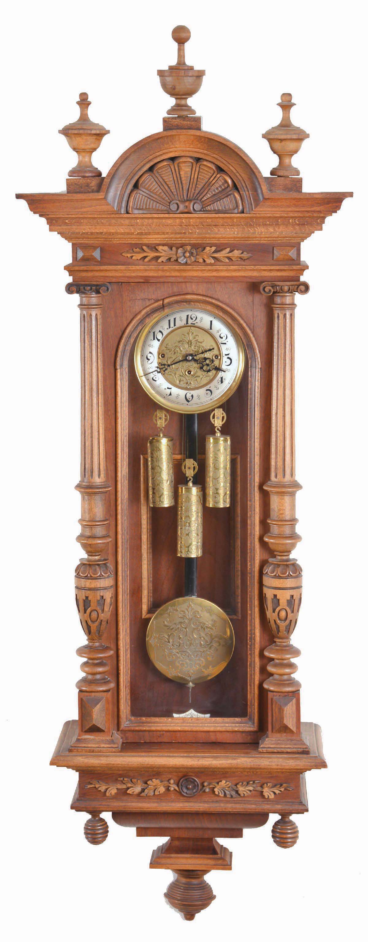 Germany / Austria, a "Vienna" regulator, grand sonnerie, 3-weight with matched pattern weights, dial and pendulum, and in a well made mixed hardwood and walnut veneer case with carved & reeded splt columns to the side of the case and with "built-in" top. The silvered brass chapter ring with Arabic numerals. — Antique Clocks Price Guide