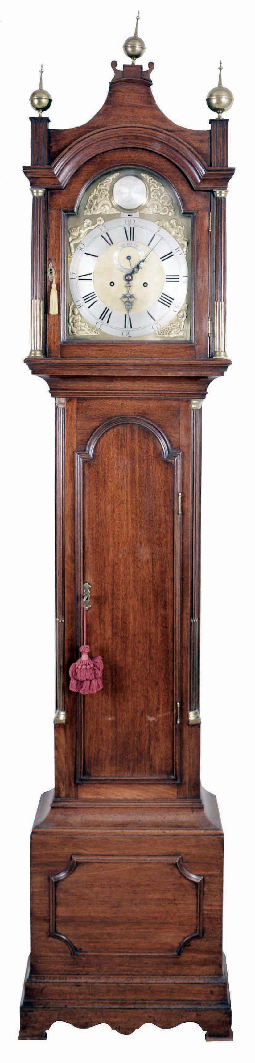 James Tregent, Leicester Square, London, tall case clock, 8 day, time and strike, weight driven movement in a mahogany case with pagoda top with stop fluted columns, three brass finials, trunk with stop fluted quarter columns and brass capitals flanking the molded tombstone door, the base with frame molded center and straight bracket feet, composite brass dial with silvered chapter ring, four seasons spandrels, maker's boss, calendar aperture above 6 and strike / silent selector, brass clad penjdulum and weights — Antique Clocks Price Guide