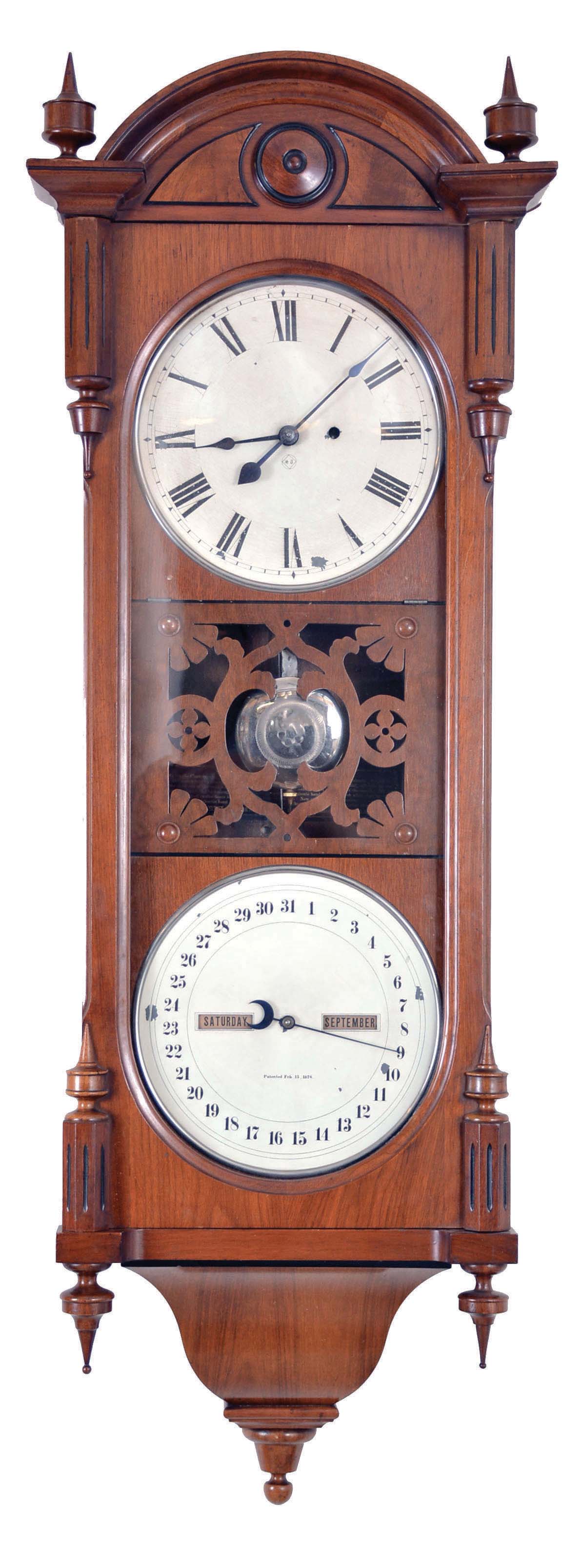 Seth Thomas Clock Co., Thomaston, Conn., "Office Calendar No. 10" (earlier version), 8 day, time and perpetual calendar, weight driven movement in a walnut case with fret work center, painted metal dials, and nickel, damascened pendulum bob. — Antique Clocks Price Guide
