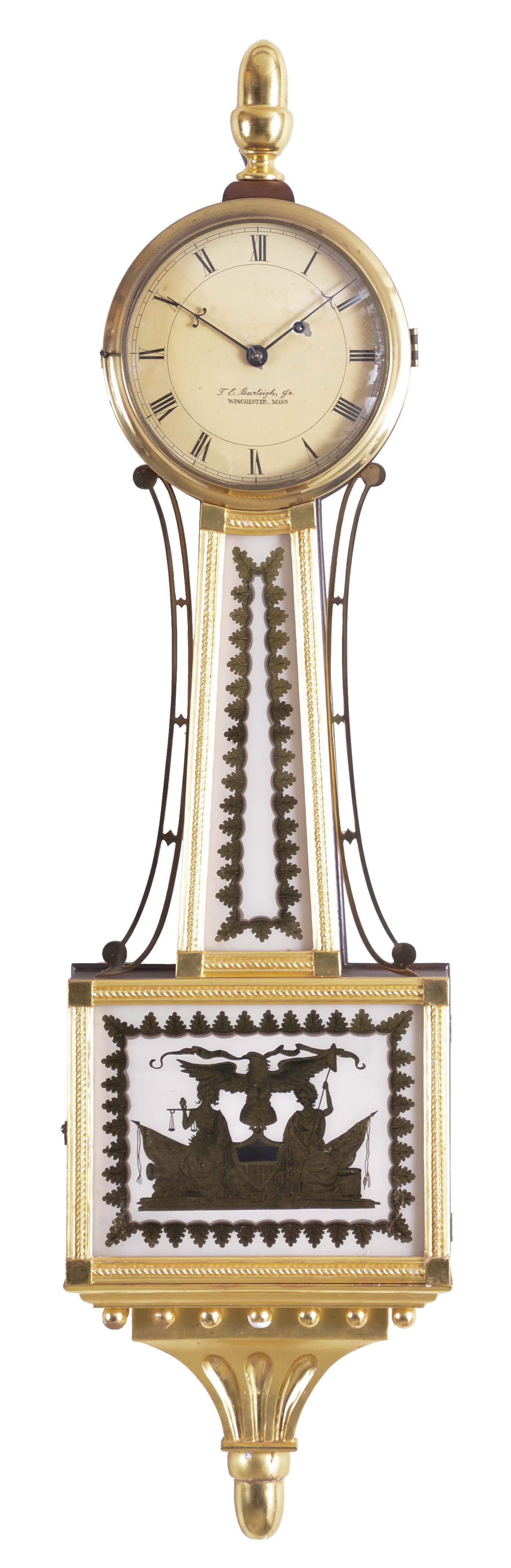 Theodore E. Burleigh, Winchester, Mass. gilt front presentation "Truth and Justice" banjo clock, with mahogany case surmounted by an acorn finial, brass bezel over the roman numeral dial signed "T. E. Burleigh, Jr./Winchester, Mass", gilded rope molded frames support reverse-painted tablets in gold and white, the lower box glass depicts Truth and Justice as mythical women holding the liberty cap and pole, and the balance scale as Justice and Equality, flanking the Federal eagle perched atop of the world globe and clutching the banner with the United States motto, "E. Pluribus Unum" (out of many, one), all set against a stage of canon balls, flags, a drum and a Federal shield as a pendulum aperture, the whole resting on a carved and gilded pediment with balls and acorn drop, eight day brass time only movement stamped "Kilbourn & Proctor Inc.", with recoil escapement, all powered by a lead weight and regulated by a brass faced pendulum bob and steel rod. — Antique Clocks Price Guide