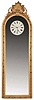 American or English, an unusual 30 day pier glass regulator with center seconds, the frame with gilt, repeating ornament and surmounted by gilt, sculptural foliate elements and central shell, the frame hinged to a pine case containing a large, 30 day weight driven timepiece movement with seconds pendulum, dead beat escapement, stop work, lantern pinions, and brass plates with turned iron pillars, mounted to a cast iron plate set into the case back, and white painted Roman numeral metal dial, with fancy, openwork blued steel moon hands, cast iron weights and wooden pendulum rod with heavy brass clad ball.