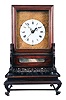 China, bracket clock reproduction, 8 day, time and strike, double fusee with crown verge escapement center seconds in a rosewood case sitting on fretwork base, white enamel dial mounted on cast brass front plate, 20th century.