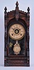 F. Kroeber Clock Co., New York, "Langtry" parlor clock, 8 day, time and strike with alarm, spring driven with walnut case, paper dial, and fancy regulating pendulum.