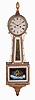 Reuben Tower, Hingham, Massachusetts Patent Timepiece "Banjo" Clock, with roman numeral iron dial signed "R. Tower/Hingham", mahogany case with gilded rope moldings enclosing the reverse-painted glasses, the throat a gilt scrolled foliate, the box glass a depiction of "Aurora", eight day time and strike movement with rack and snail hour strike on a top mounted bell, powered by two cast iron weights and regulated by a pendulum.
