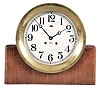 Chelsea Clock Co., Boston, Mass, "Mahogany and Metal" ship's clock, 8 day, time and ship's bells, spring driven jeweled movement in a heavy cast brass case with hinged bezel, 8 inch signed silvered dial, all on a rectangular mahogany stand. Serial number 527160.