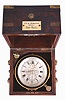 T.S. and J.D. Negus, New York, a good two day marine chronometer with original box, 11 jewel, free sprung fusee movement with Earnshaw's spring detent, cut, bimetallic chronometer balance with blued helical spring, and diamond endstone, signed Roman numeral silvered dial with wind indicator, gold spade and poker hands, contained in a lacquered brass bowl with gimbals, and mounted in a mahogany and rosewood veneer box with brass furniture, and plaque engraved "T.S. & J.D. Negus 1603 New York", the box also with rating certificate from L. A. Karcher & Co., Boston