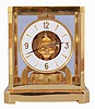 Jaeger- LeCoultre, Switzerland, "Atmos" clock, 15 jewel movement, gilt torsion pendulum, round white painted dial with applied gilt Arabic numerals and arrow markers, gilt hands with black painted tips, all contained in a glazed rectangular case with removable front panel, serial #506271, c1979.