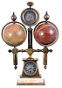 France, an unusual desk compendium, with celestial and terrestrial globes by Delamarche, the trapezoidal clock case on an onyx and brass base, supporting a central pilaster with thermometer, and surmounted by a barometer and compass, and with flanking, lithographed globes, signed "Delamarche Rue Serpente 25 Paris", Roman numeral silvered dial, blued steel distaff hands, 8 day timepiece movement with cylinder platform