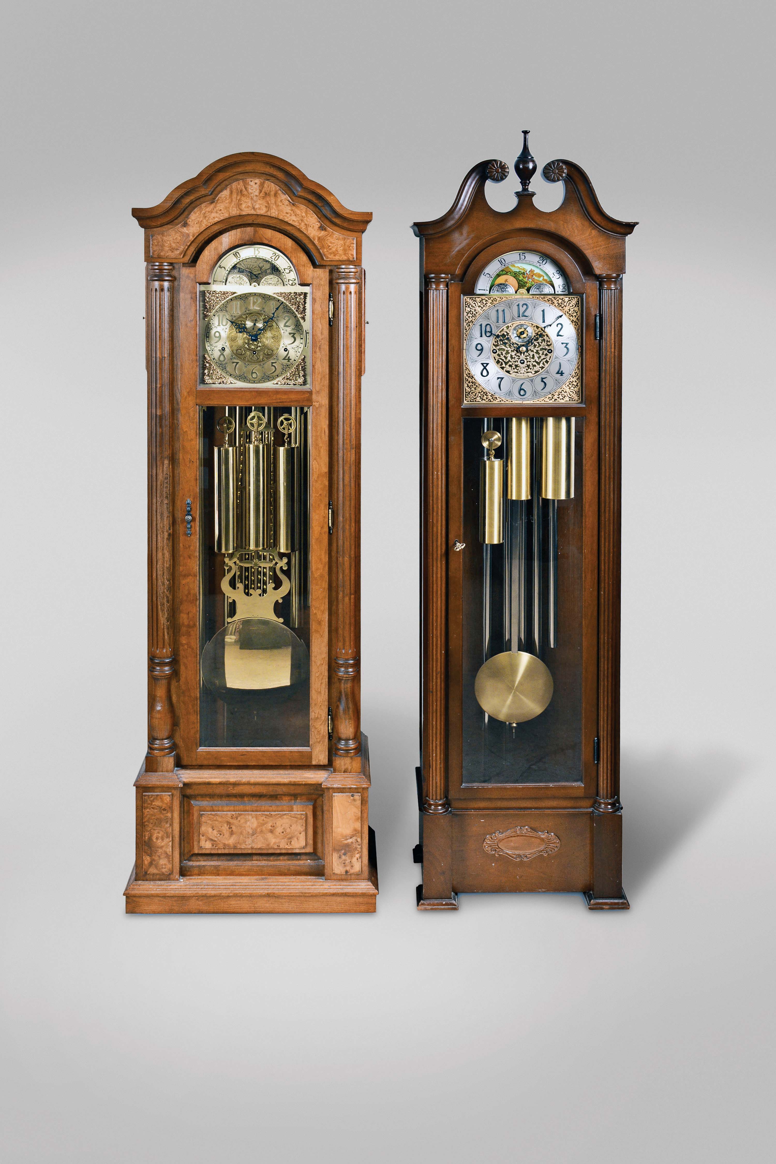 Tall Clocks- 2 (Two) mid 20th century, 8 day, time, strike and tubular chime, weight driven movement with moon phase in walnut and glass cases: (1) Emperor Clock Co., Amherst, VA, beveled glasses, 9 tubes, playing three tunes, Westminster, Whittington, St. Michael's; (2) Herschede Clock Co., Cincinnati OH, Westminster chime only — Antique Clocks Price Guide