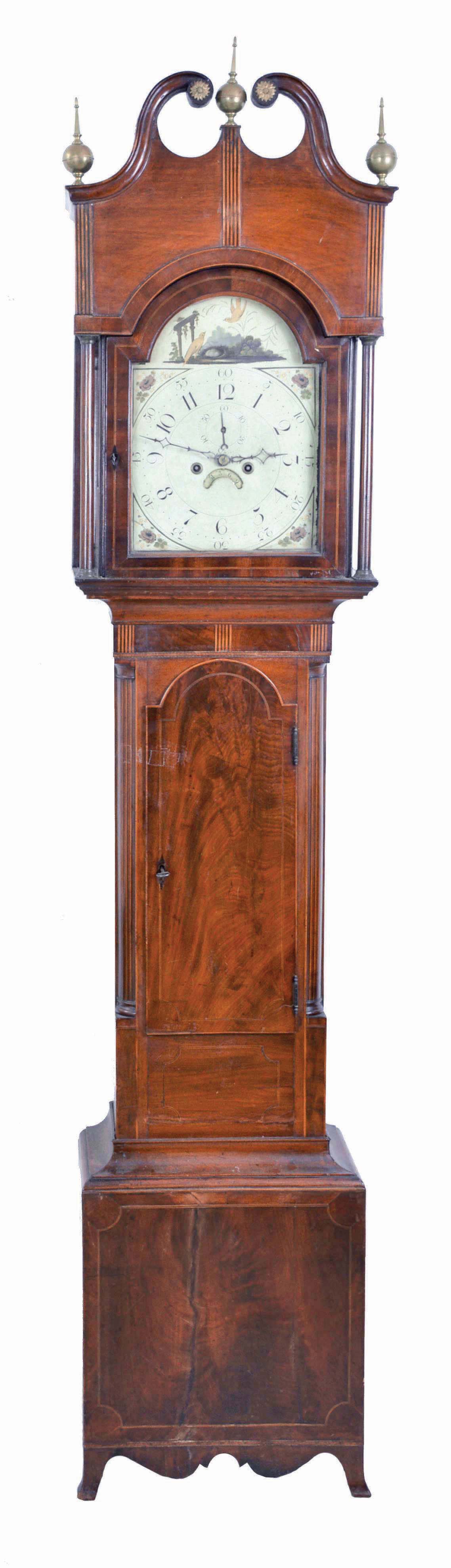 New Jersey or New York tall clock, 8 day, time and strike, weight driven movement in a mahogany and mahogany veneer broken arch case with French feet, banded inlay around plinth, center panel, trunk and hood door, ebony striping on four full columns flanking hood, three brass finials, brass rosettes on broken arch and crotch mahogany trunk door and plinth. The painted metal dial has bird's nest in arch and painted floral spandrels and calendar disc under center arbor. — Antique Clocks Price Guide