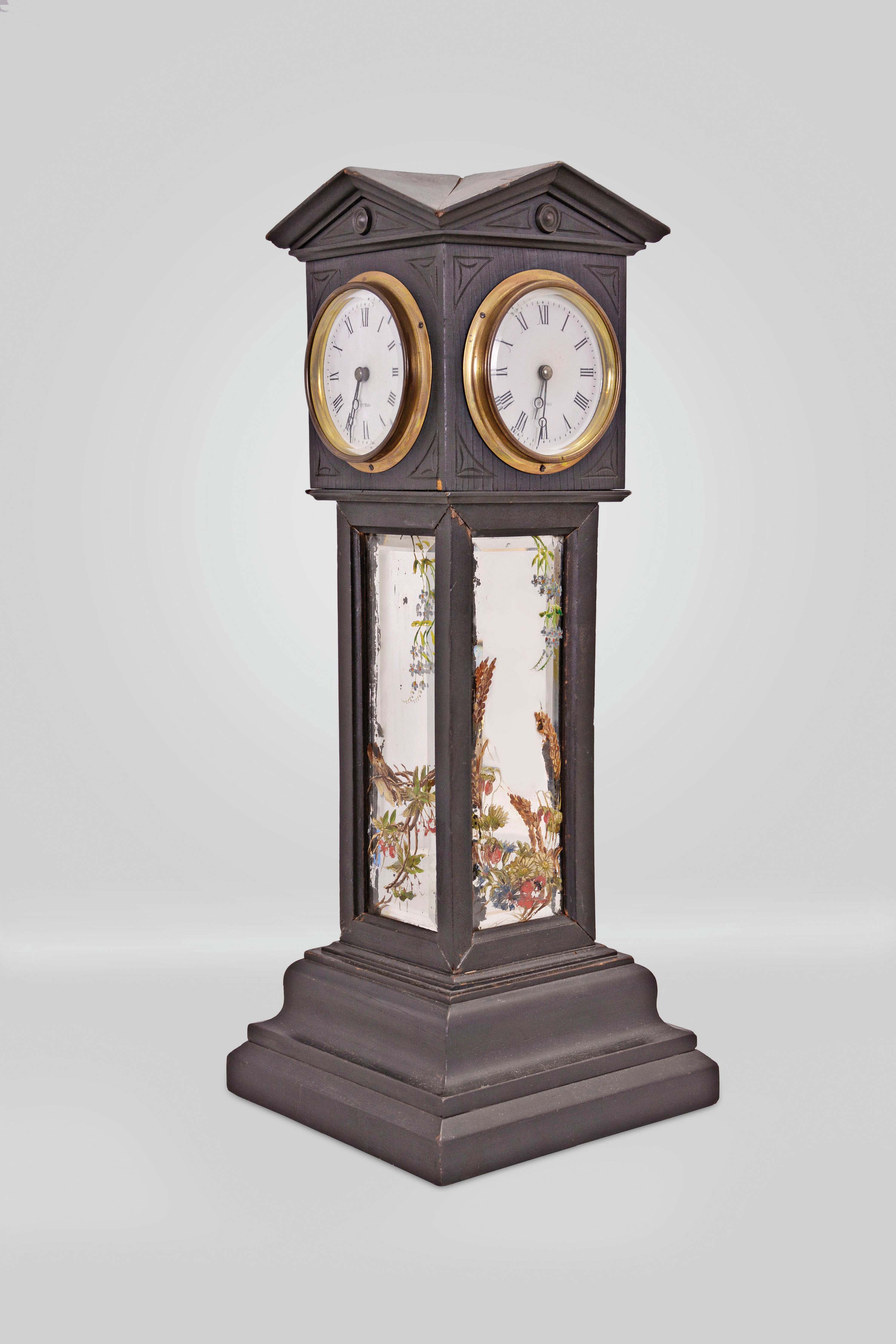 Blumberg and Co. Ltd., Paris & London, a four dial, architectural, tower form clock, the ebonized case with deeply molded, stepped base, supporting cavetto molded frames containing beveled mirrors with polychrome painted floral ornament, and surmounted by a cube with pedimented top, containing the transmission gearing for four, roman numeral white enamel dials with blued steel Breguet style hands and beveled glasses in brass bezels, the dials signed "Hry. Marc", the base containing an 8 day, timepiece with oval plates and lever platform, the base also bearing an embossed, brass tag marked "Patent Brevete S.G.D.C. Blumberg & Co. Ltd Paris & London" — Antique Clocks Price Guide