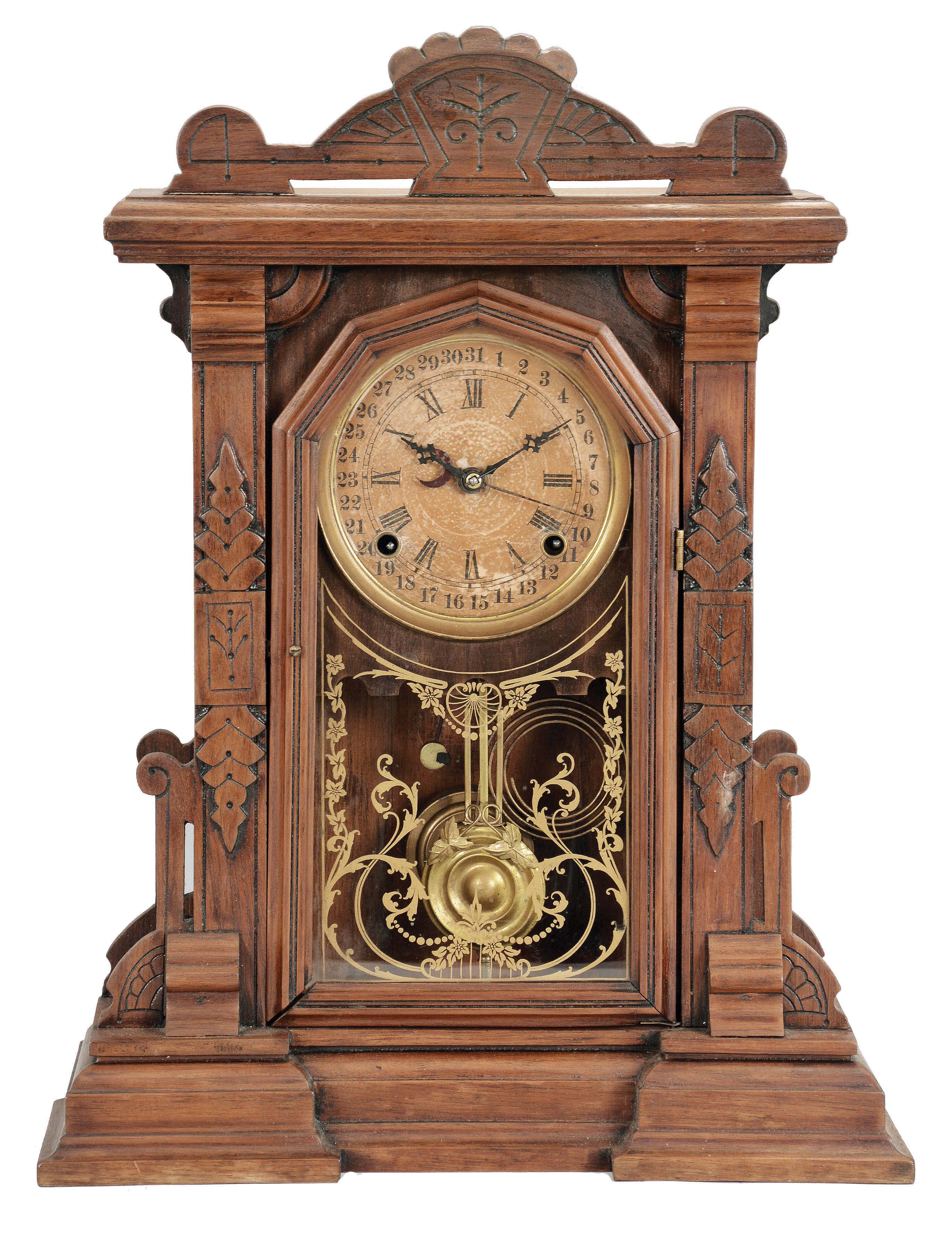 E. Ingraham & Co., Bristol, Conn., premium model made expressly for the Lovell Manufacturing Co., Philadelphia. This is a shelf clock with a spring driven, 8 day, time and strike movement with a simple calendar mechanism in a walnut case. — Antique Clocks Price Guide