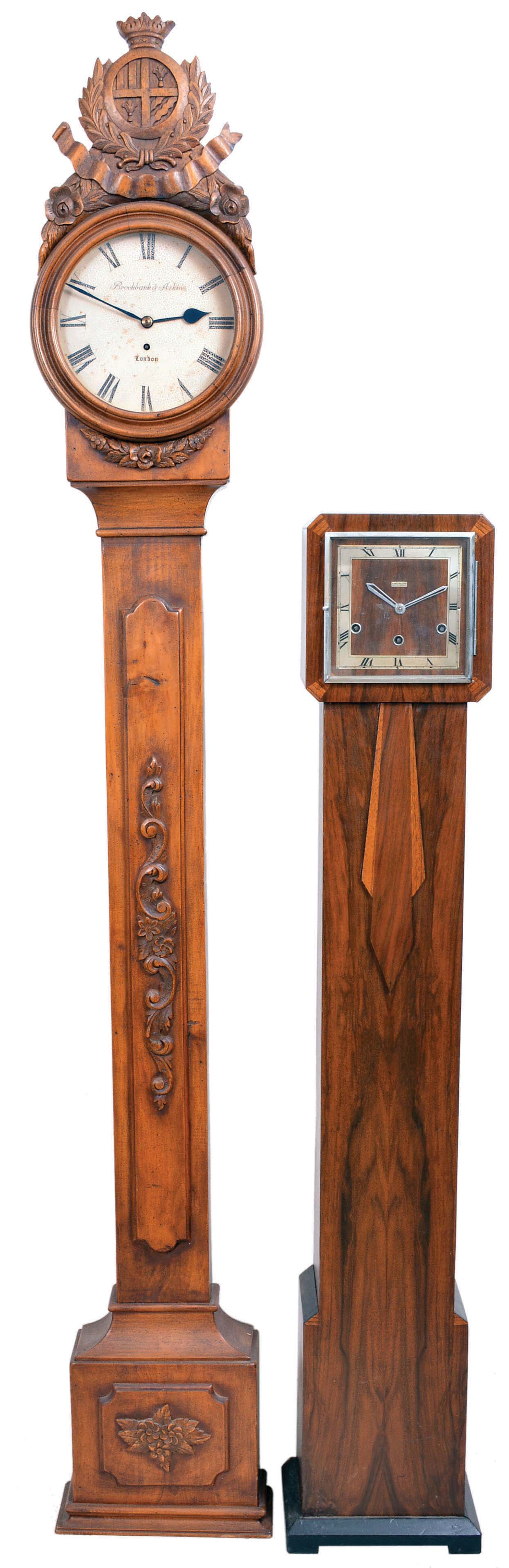 Clocks- 2 (Two) English Floor Standing: (1) Perivale/Anvil, London for B. Walton & Sons, Chester, floor standing clock, 8 day, three train Westminster chime, spring-driven movement in an Art Deco walnut case with square chapter, c. 1930; (2) Brockbank & Atkins, London, floor clock, 8 day, time only, spring-driven fusee movement in a pine case with carved applied ornaments and crest, painted metal dial, c1890. — Antique Clocks Price Guide