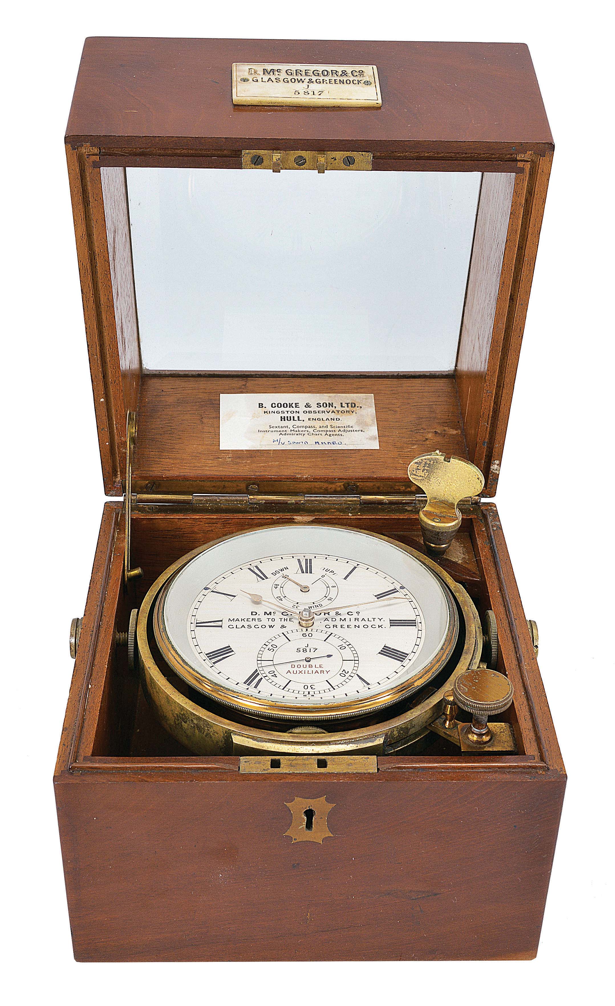D. McGregor and Co., Glasgow & Greenock, a two day marine chronometer with double auxiliary balance, 10 jewel fusee movement with Earnshaw's escapement, and freesprung, cut bimetallic balance with Poole's and Eiffe's auxiliary compensation, diamond endstone, and blued steel helical balance spring, Roman numeral silvered dial with wind indicator, gold spade and poker hands, contained in a lacquered brass bowl, and mounted in an associated two tier mahogany box with gimbals, bevelled glass top, and lacquered brass furniture, serial #J/5817 — Antique Clocks Price Guide
