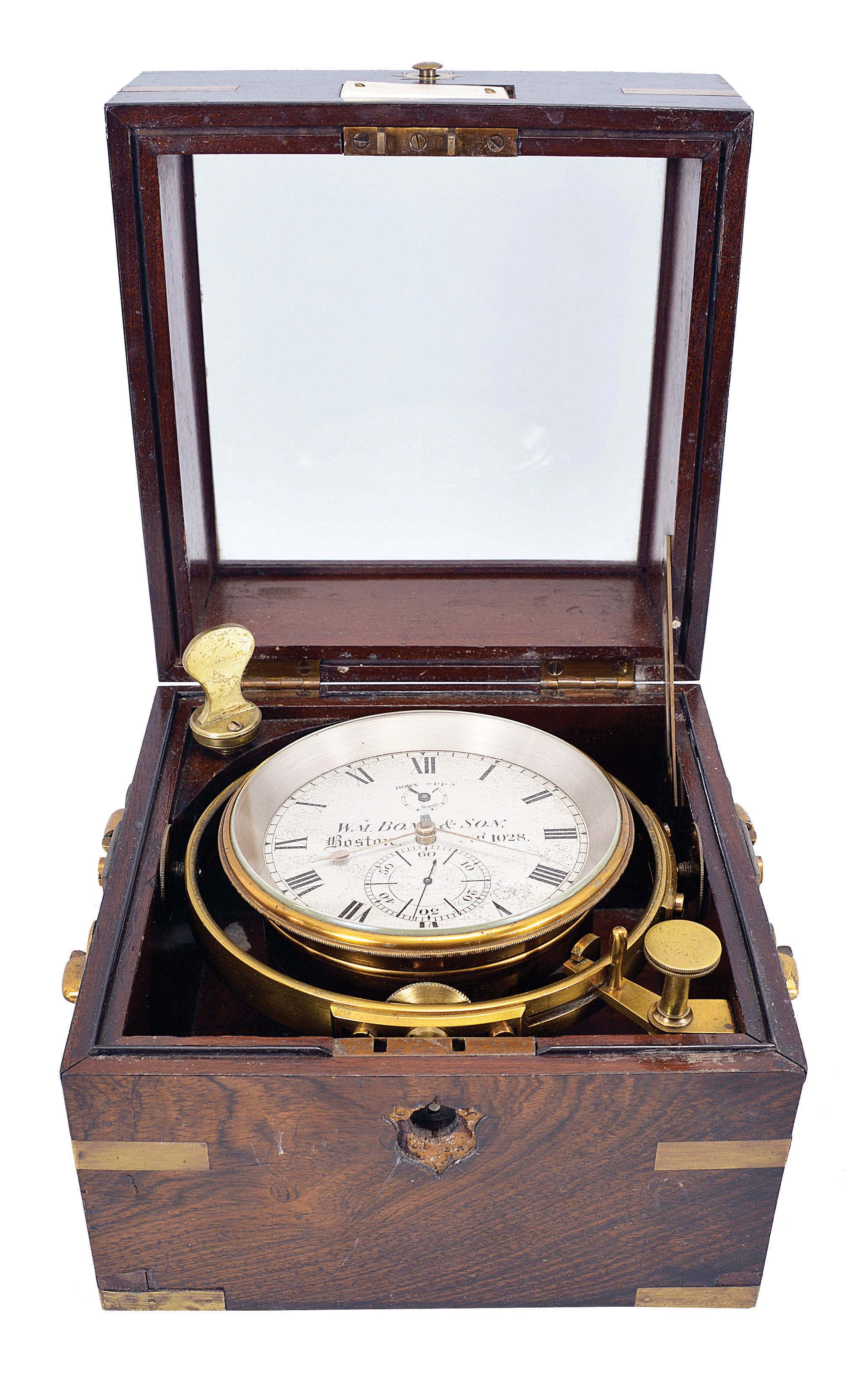 Wm. Bond & Son, Boston, two day marine chronometer, 11 jewel fusee movement with decorative scraping, Earnshaw's escapement, freesprung, cut bimetallic "Z" balance, diamond endstone, and blued steel helical balance spring, Roman numeral silvered dial with wind indicator and gold spade and poker hands, with gimballed, lacquered brass bowl, and contained in a two tier rosewood box with brass furniture, serial #1028 — Antique Clocks Price Guide