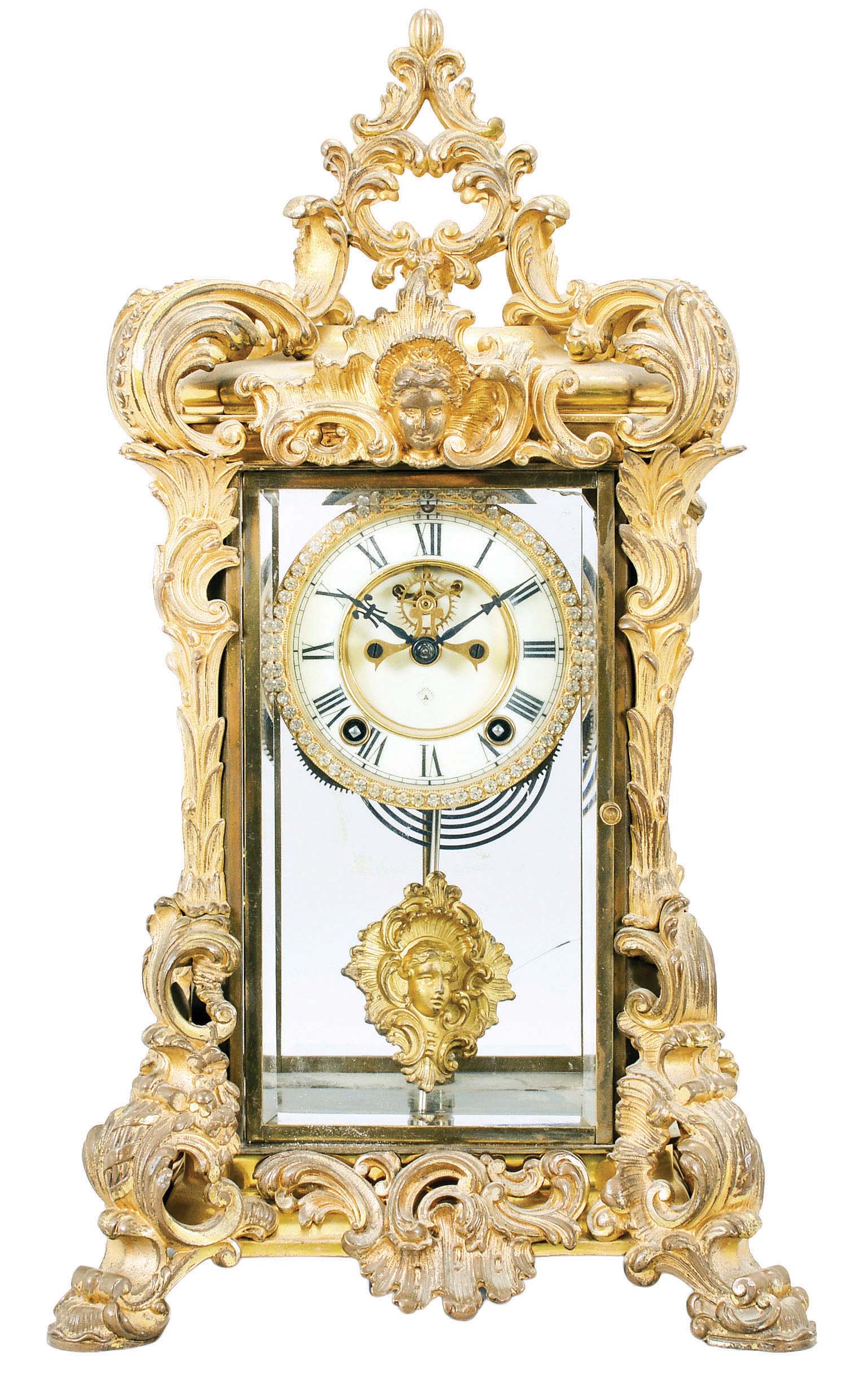 Ansonia Clock Co., New York, "Apex" crystal regulator shelf clock with a spring driven time and half hour rack strike movement with a visible escapement, a fancy pendulum and jewelled bezel in a rich gold and brass case. — Antique Clocks Price Guide
