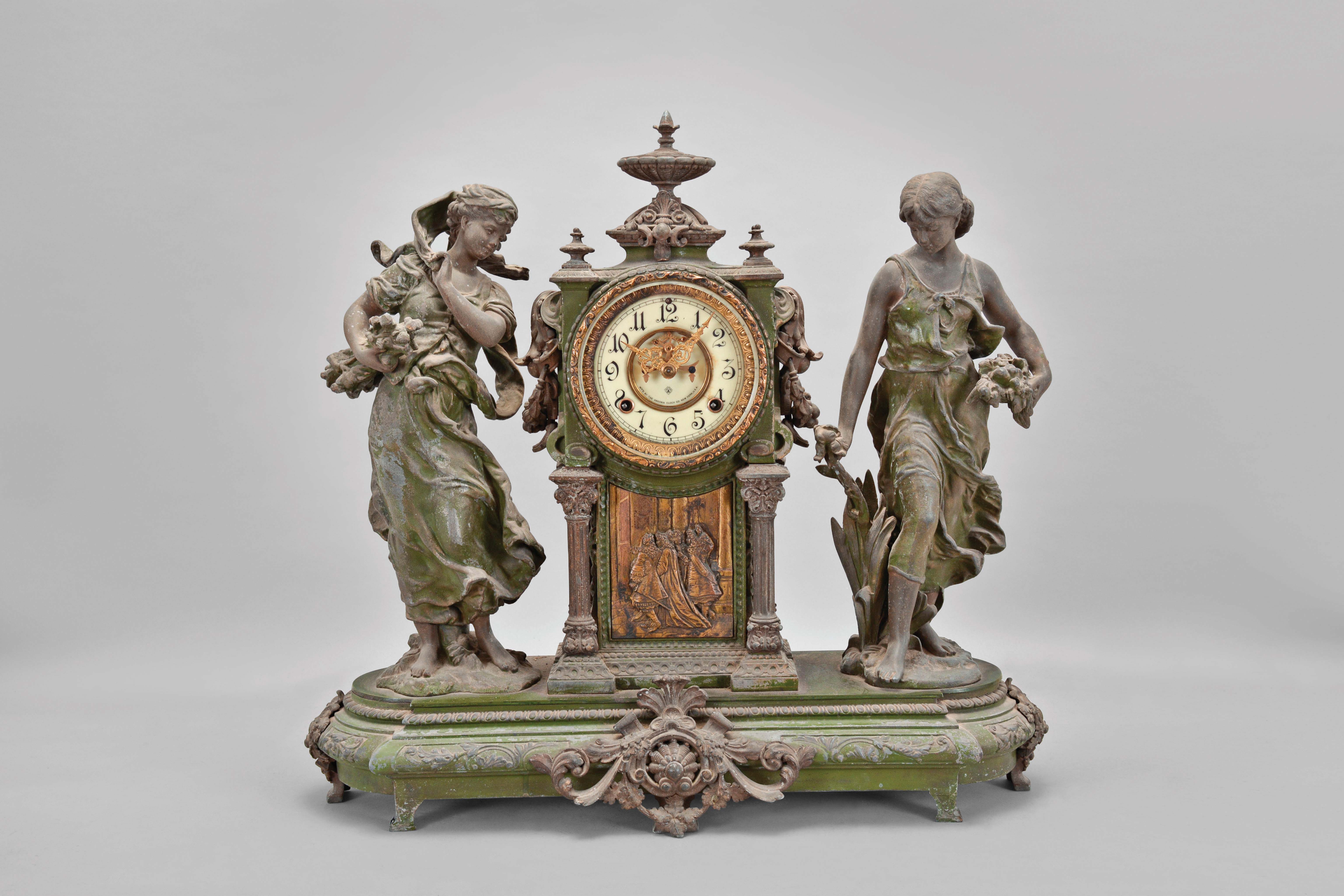 Ansonia Clock Co., New York, "Summer and Winter" double figural shelf clock with a spring driven, 8 day, time and strike visible escapement movement in a cast spelter case on a green enameled base. — Antique Clocks Price Guide