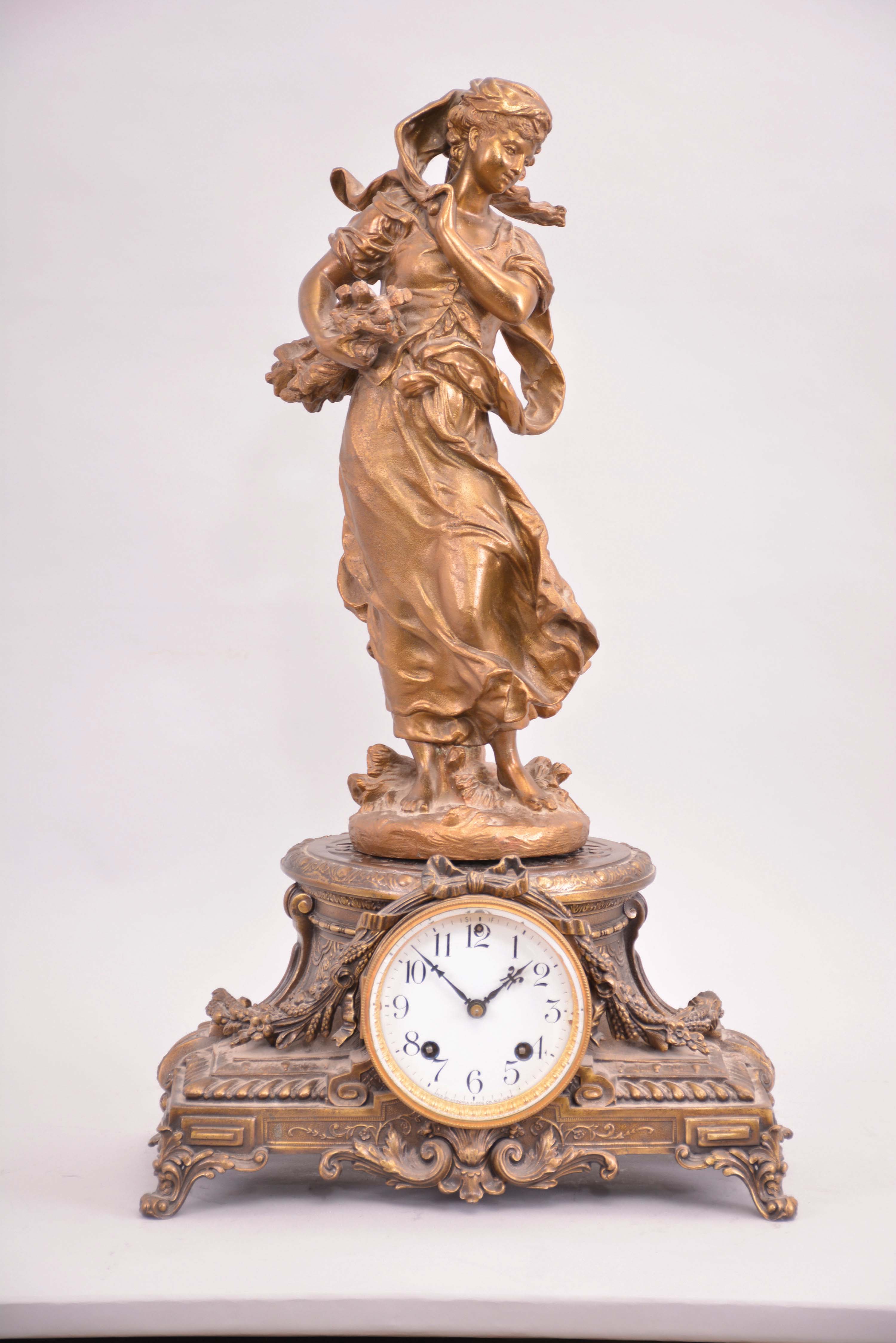 Ansonia Clock Co., New York, "Winter (figure) and Hebe (base) " figural shelf clock with a spring driven, 8 day, time and half hour strike movement in a bronzed spelter case. — Antique Clocks Price Guide
