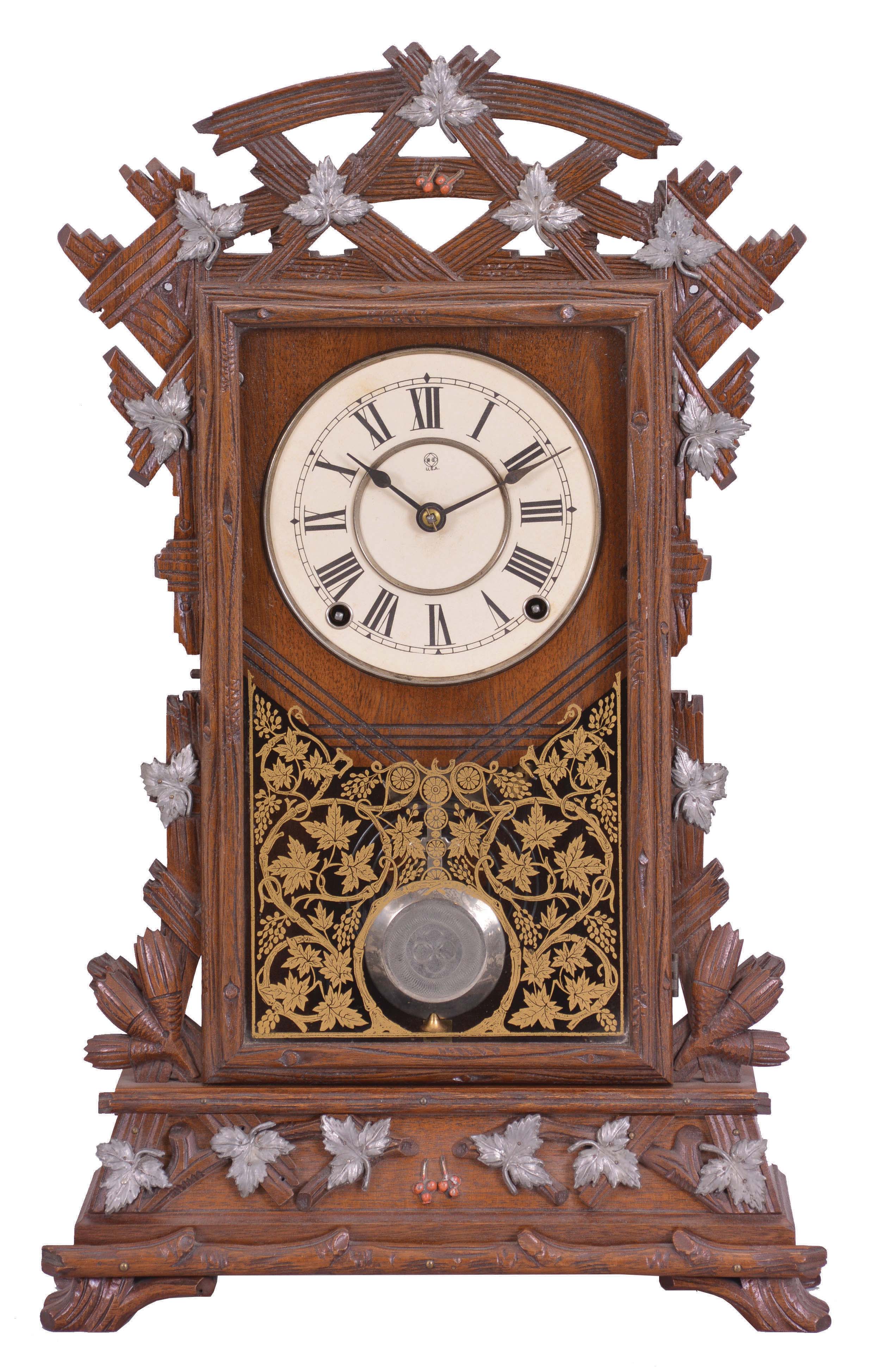 Seth Thomas Clock Co., Thomaston, Conn., "Santa Fe" shelf clock with a spring driven, 8 day, time and strike lyre movement in a walnut case with applied metal leaf decorations. — Antique Clocks Price Guide