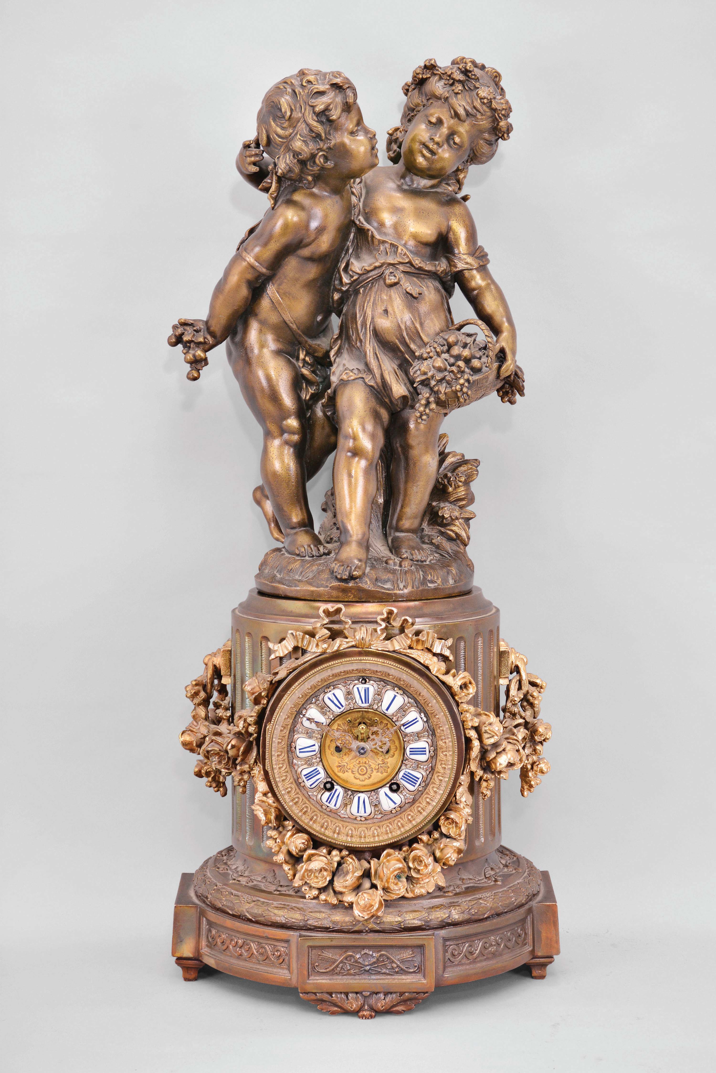 Ansonia Clock Co., New York, "Florida" base with figural "Group No. 1089" shelf clock, 8 day, time and strike, spring driven movement with visible Brocot escapement in a festooned fluted column topped by two children. — Antique Clocks Price Guide