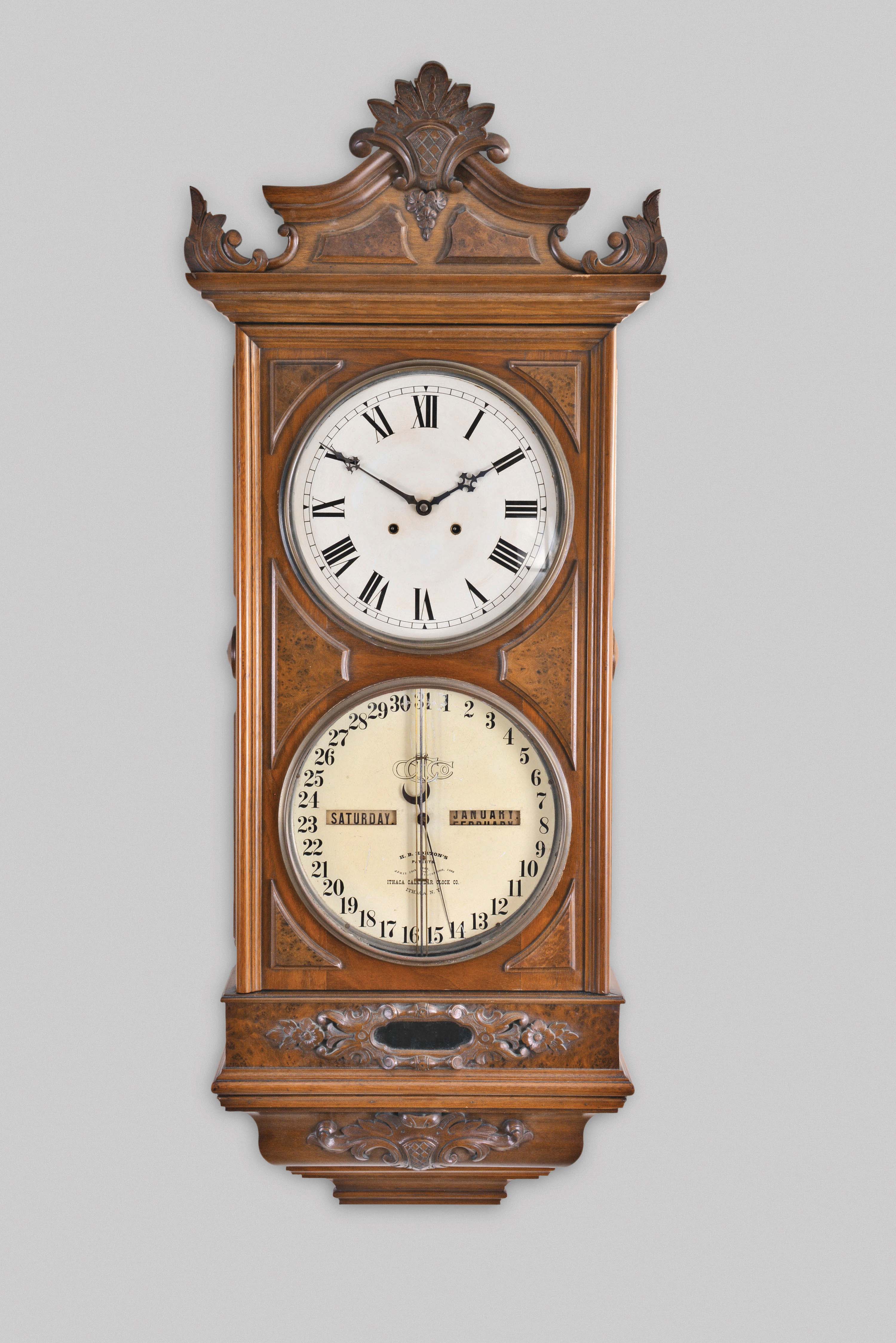 Ithaca Calendar Clock Co., Ithaca, New York, "No. 0 Regulator" hanging clock with a weight driven, 8 day, timepiece movement (Welch, Spring & Co.) and a H. B. Horton patented perpetual calendar mechanism in a walnut case with burl walnut accents. — Antique Clocks Price Guide