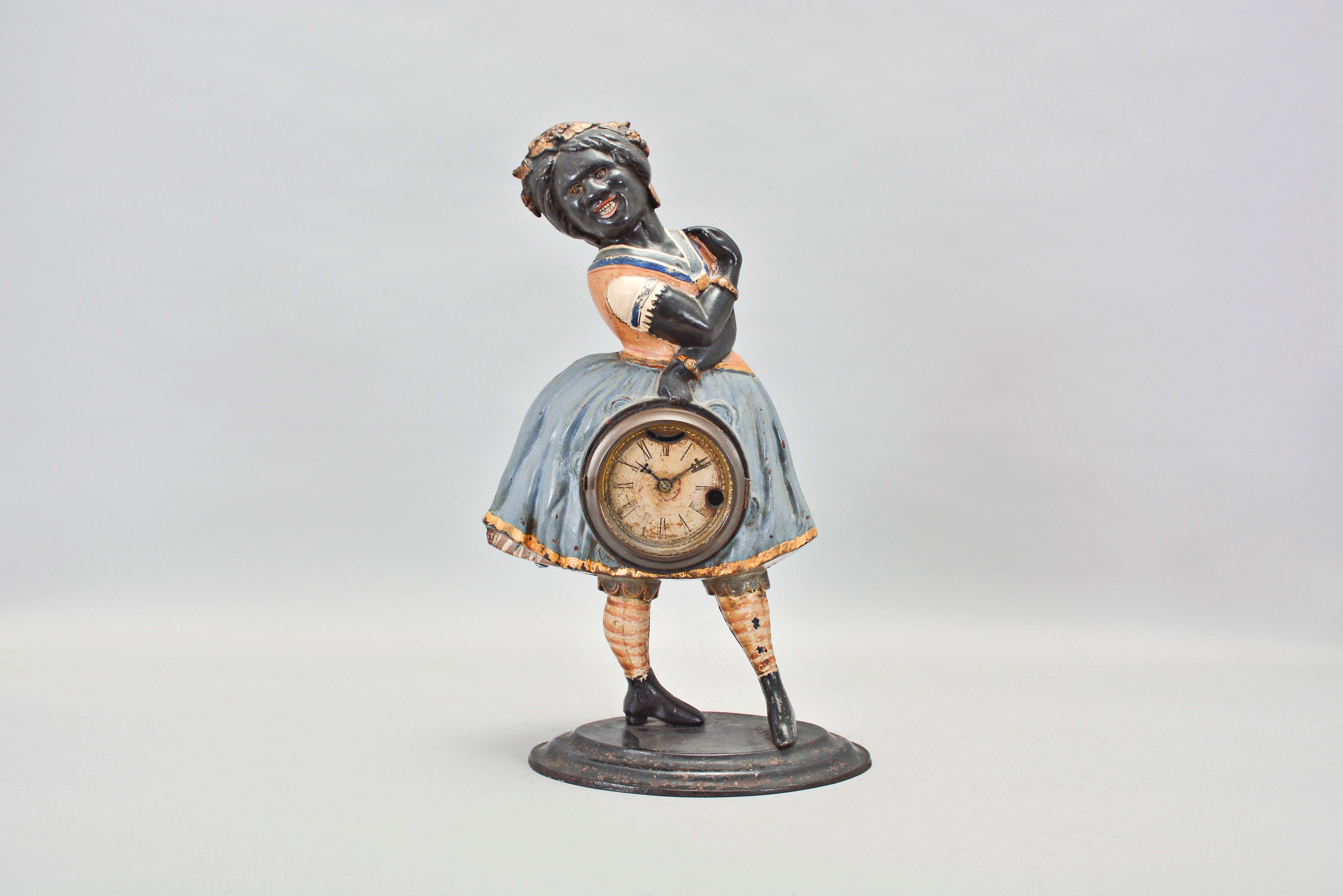 Bradley & Hubbard, Meriden, Conn., "Topsey" blinking eye shelf clock with a spring driven, 30 hour, timepiece with a balance wheel escapement in a painted cast iron case. — Antique Clocks Price Guide