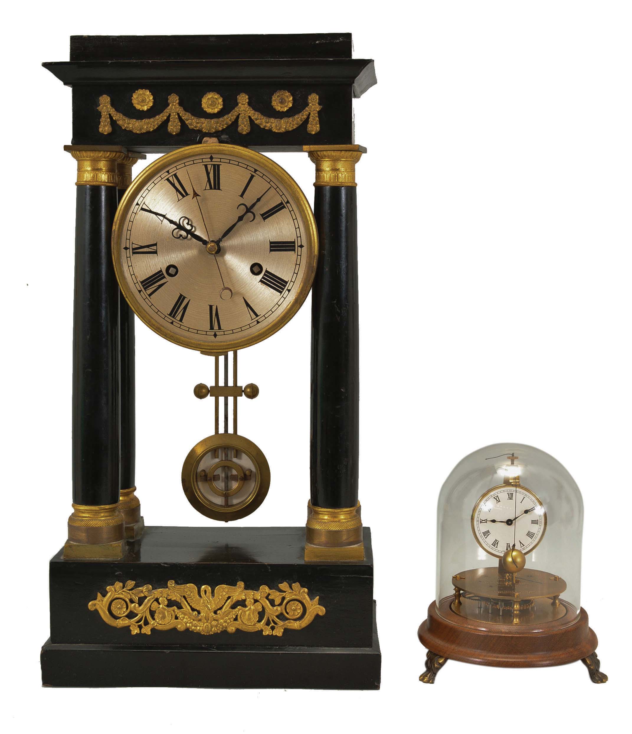 Clocks- 2 (Two) Unusual Mantel: (1) France, Empire portico clock, long duration, time and bell strike, spring-driven movement with pinwheel escapement, vernier beat adjustment, and center seconds in a four-column ebonized case with applied gilt ornaments, silvered dial, and blued steel hands, c1830. (2) GermaNew York, Horolovar / Clocktrade Enterprises, Bronxville, New York, reproduction Briggs rotary timepiece, 8 day, time only, spring-driven movement with conical pendulum on a turned wood base with brass feet, all under a glass dome, number 957 of 2000, c1975. — Antique Clocks Price Guide