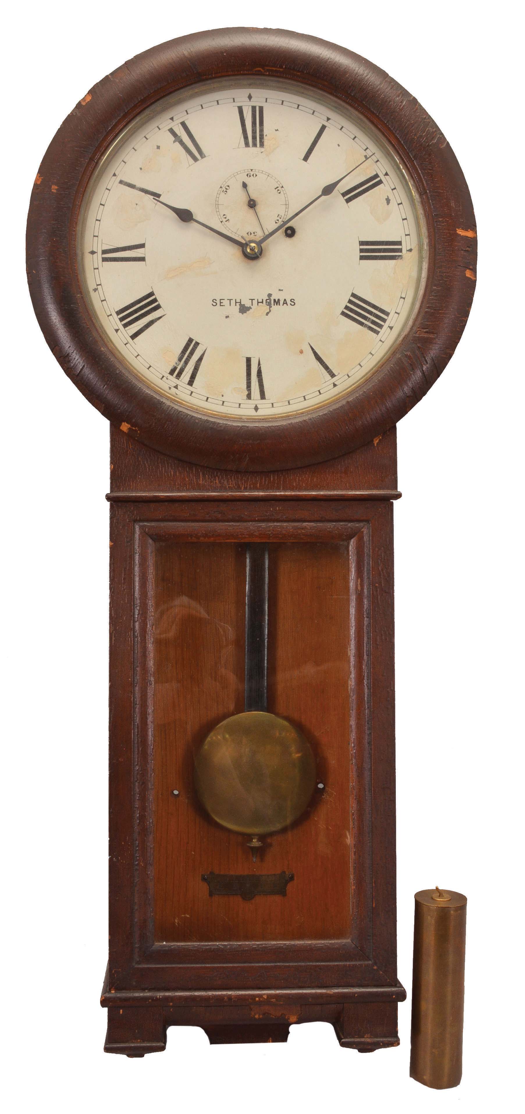Clocks- 2 (Two) (1) Seth Thomas Clock Co., Thomaston, Conn., "Regulator No. 2" wall clock, 8 day, time only, weight driven movement in an oak case with painted metal dial, spade hands and subsidiary seconds, c1894. (2) Germany, wall hanging box clock, 8 day, time and strike, spring-driven movement in a dark oak case with white enamel dial, and blued steel spade hands. — Antique Clocks Price Guide