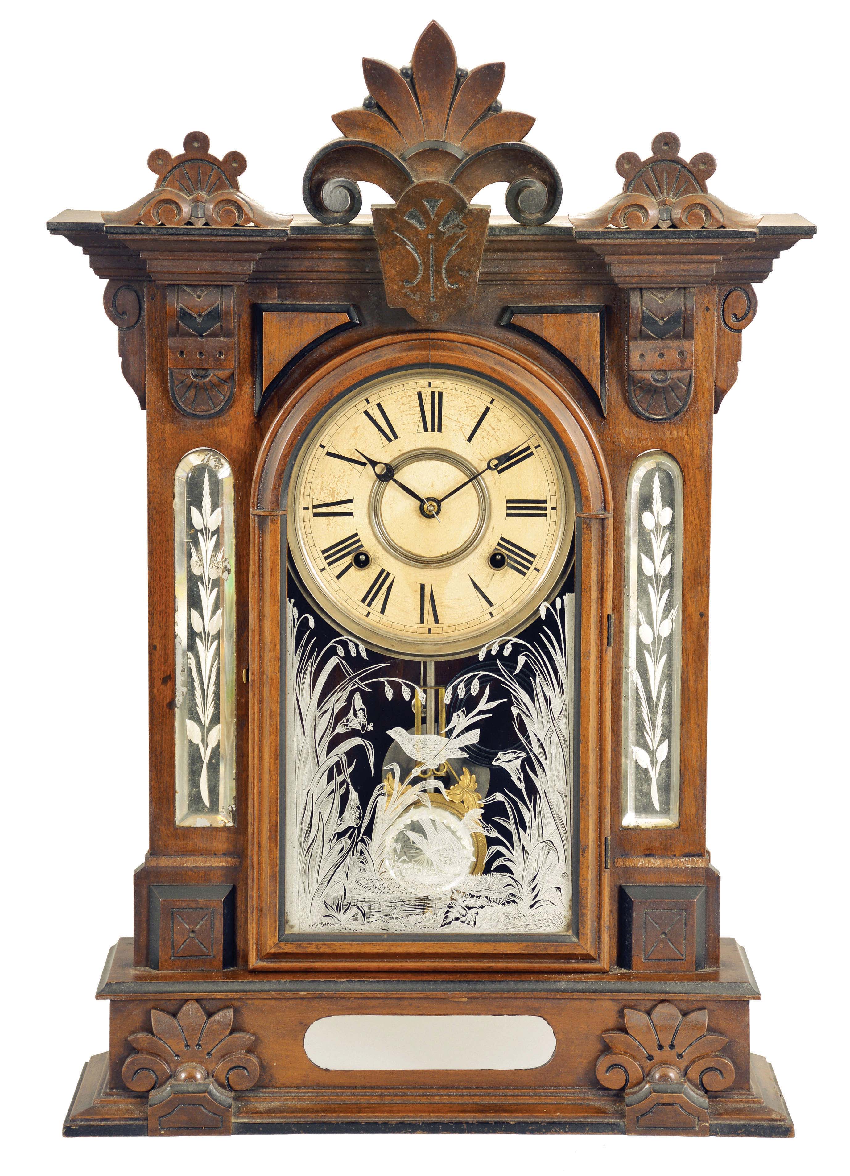 William L. Gilbert Clock Co., Winsted, Conn., "Amphion" shelf clock with a spring driven, 8 day, time and strike movement in a walnut case and cut glass mirror panels in the case. — Antique Clocks Price Guide