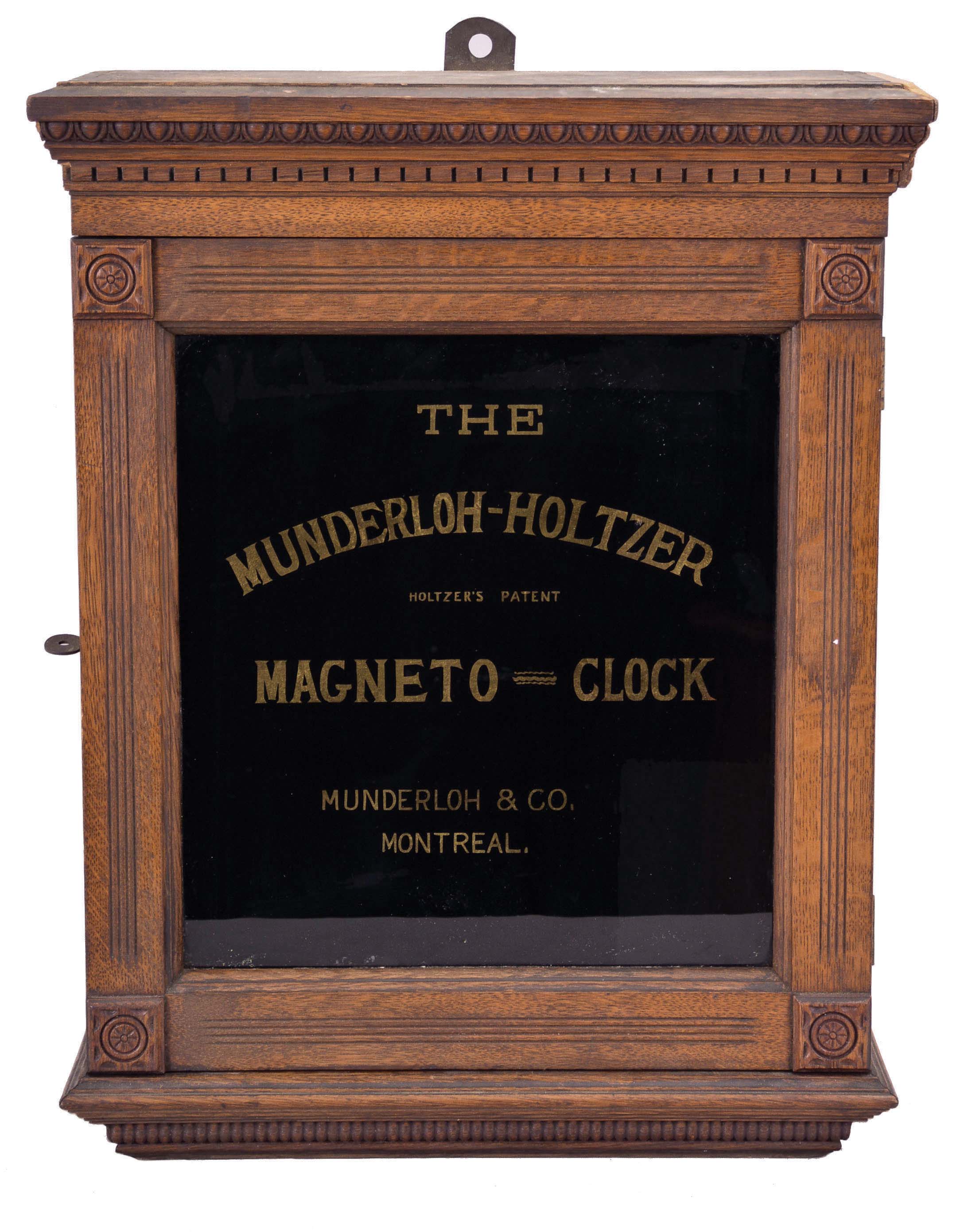 Munderloh and Co., Montreal, Canada, "Munderloh-Holtzer Magneto Clock", 8 day, time and recorder function for 6 watchman's stations, twin-spring balance wheel movement in an oak case with black glass and gold leaf lettering which reads in part "The Munderloh-Holtzer Magneto Clock / Holtzer's Patent". — Antique Clocks Price Guide
