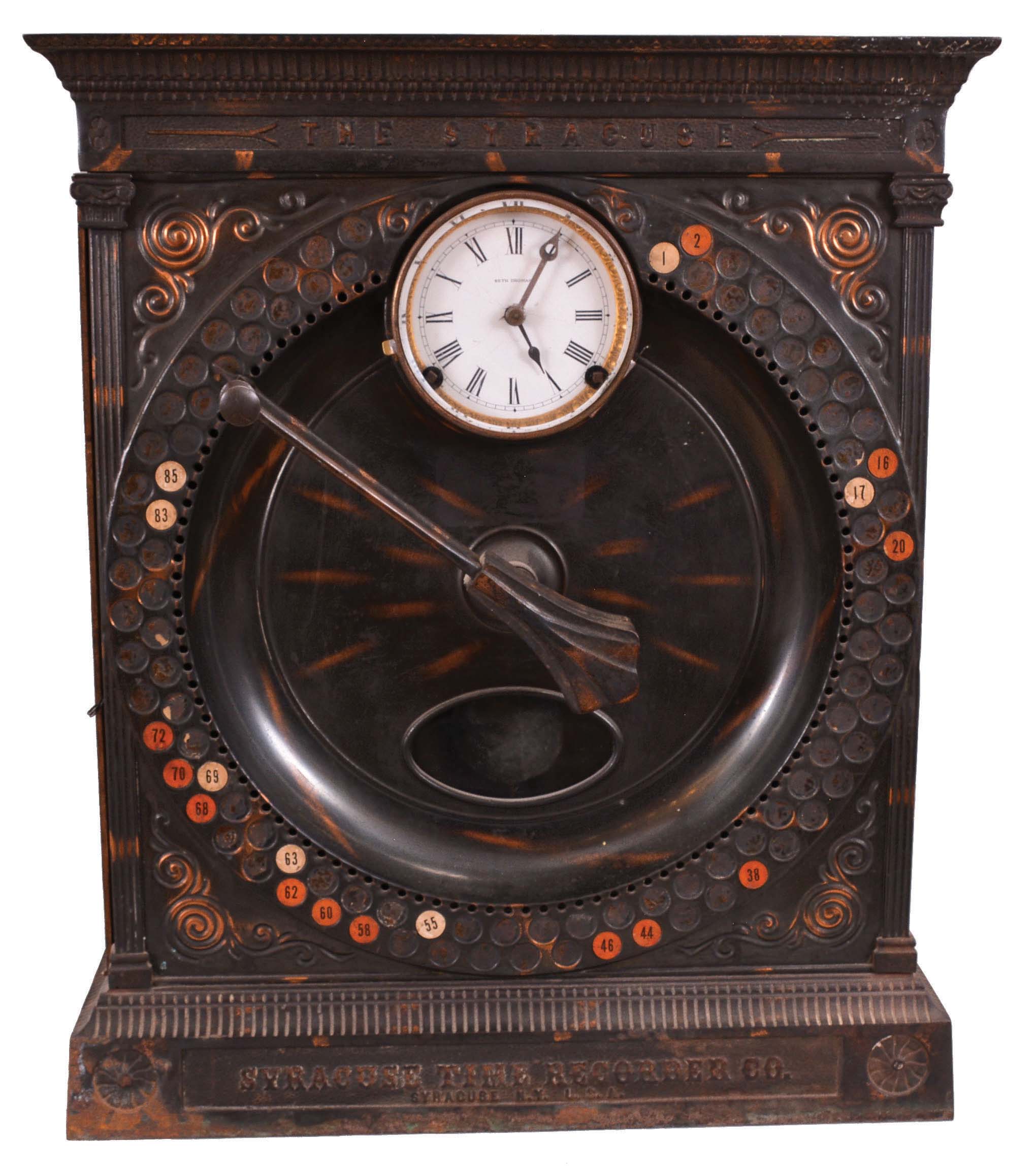 Syracuse Time Recorder Co., Syracuse, New York, time recorder, 8 day, time and recorder function, twin-spring pendulum movement in a heavy cast iron case with embossed copper front, having a white porcelain dial signed by Seth Thomas, all atop the cast base with the name of the compaNew York and 1904 patent dates. — Antique Clocks Price Guide