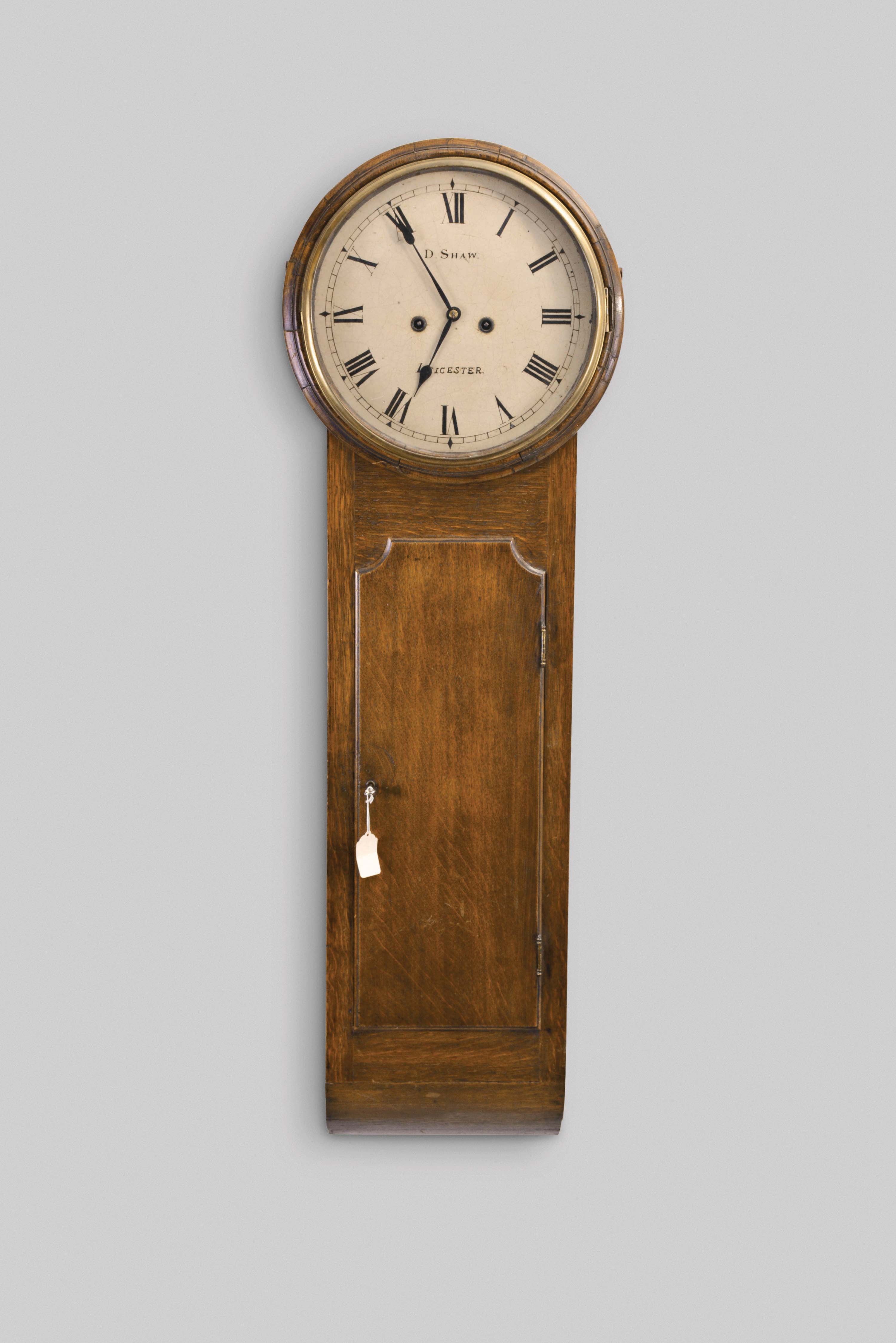 D. Shaw, Lancaster, England, tavern wall clock, 8 day, time and strike, weight driven movement in an oak case with painted metal dial — Antique Clocks Price Guide