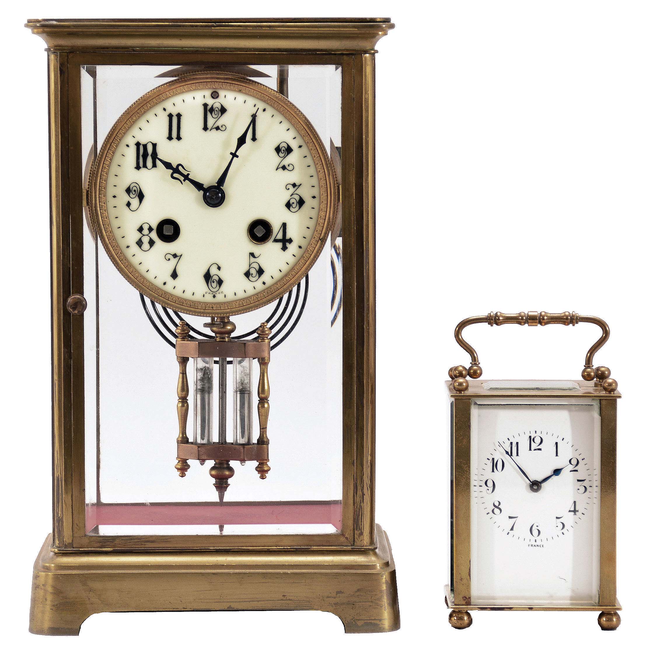 Clocks- 2 (Two) French Brass and Glass: (1) Japy Freres & Cie., Paris, crystal regulator, 8 day, time and gong strike, spring-driven pendule de Paris movement with double-vial pendulum in a glazed case with beveled glasses, gilt brass corners, top and bottom, 3.5 inch cream porcelain dial with Arabic numerals and blued steel hands. (2) France, carriage clock, 8 day, time only, spring-driven movement in a glazed case with beveled glasses on five sides, polished brass case with handle on top, white enamel dial with Arabic numerals, and blued steel spade hands. — Antique Clocks Price Guide